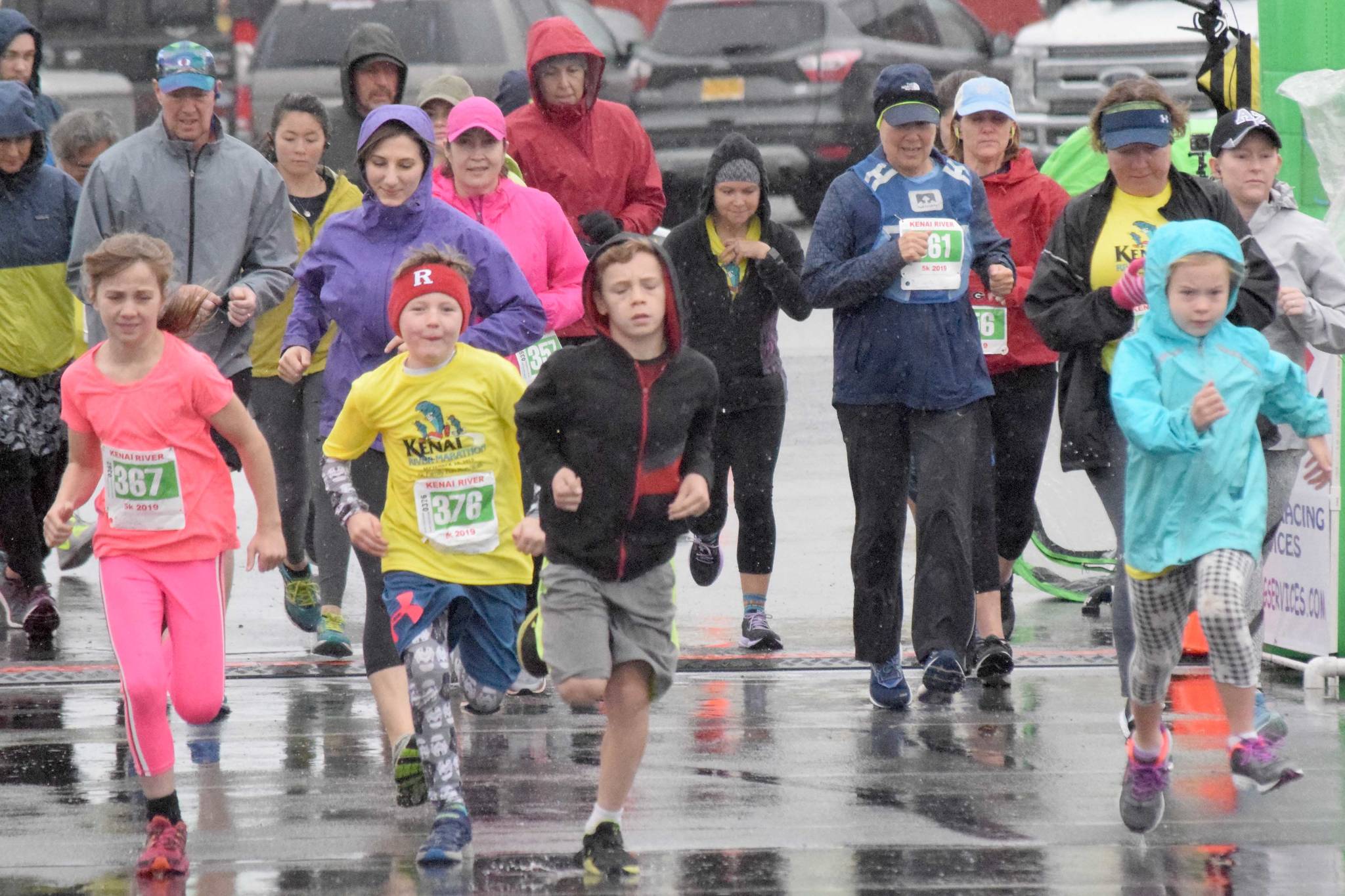 Runners dash from the start of the 5-kilometer race Sunday, Sept. 29, 2019, at the Kenai River Marathon. (Photo by Jeff Helminiak/Peninsula Clarion)