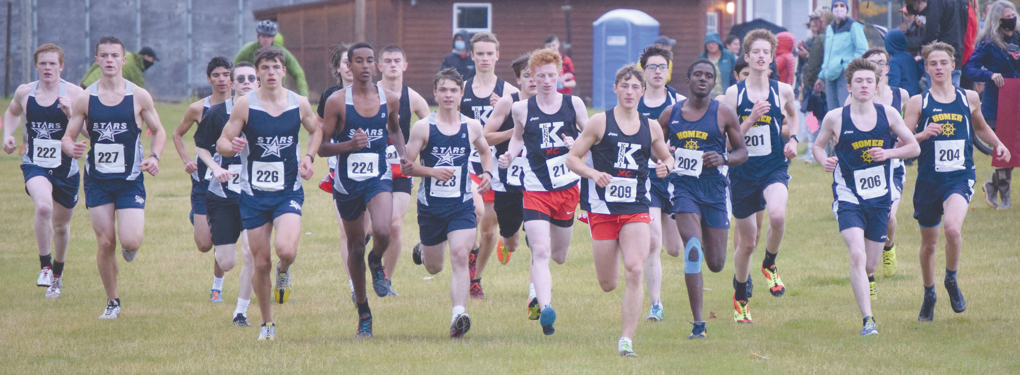 Kenai Centrals Maison Dunham (209) takes the lead at the start en route to victory in the Kenai Peninsula Borough cross-country race Saturday, Sept. 26, 2020, at Tsalteshi Trails just outside of Soldotna, Alaska. (Photo by Jeff Helminiak/Peninsula Clarion)