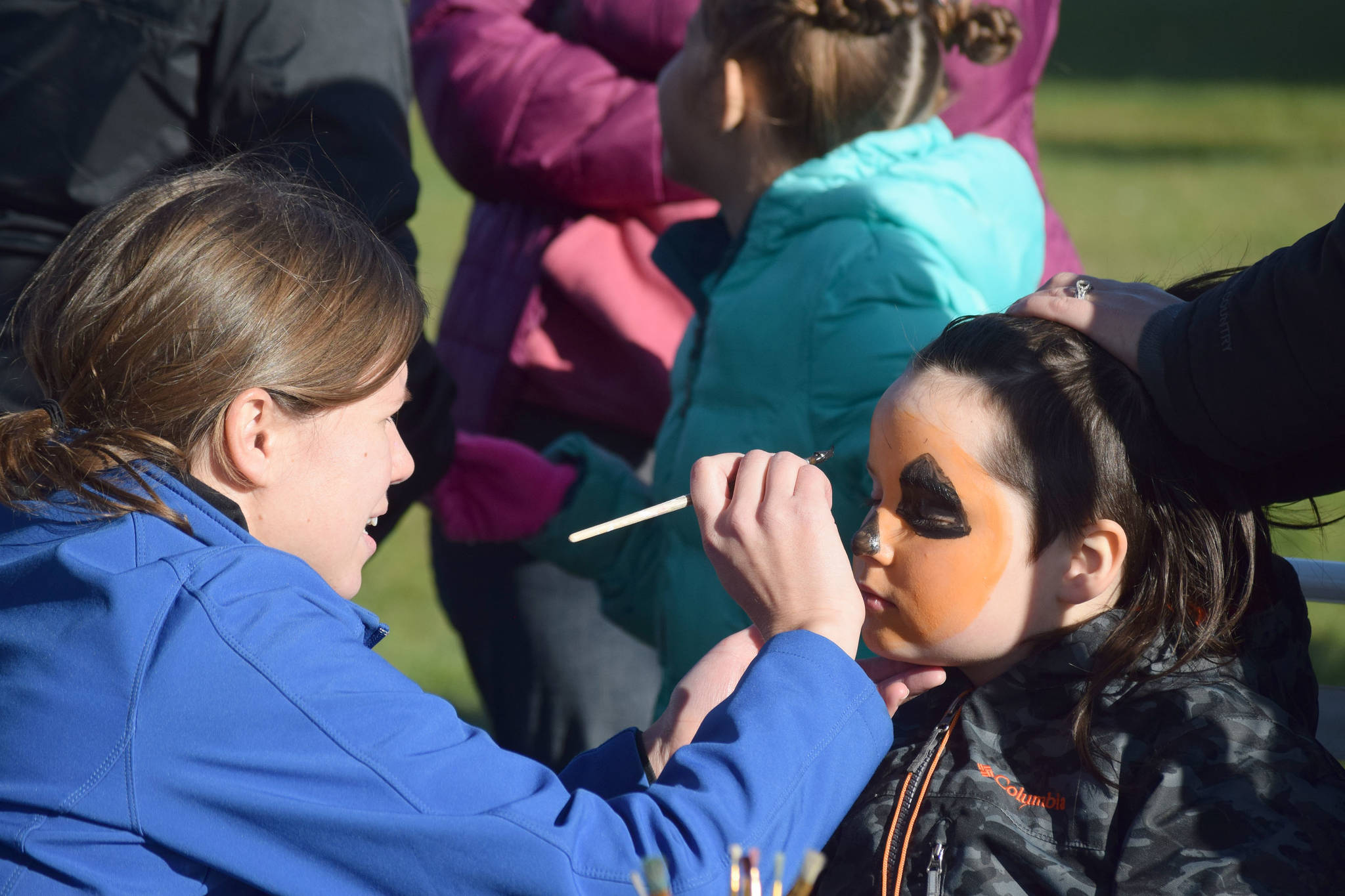 Children get their face painted Saturday, Oct. 12, 2019, at the fourth annual Fall Pumpkin Festival at Millenium Square in Kenai, Alaska. (Photo by Joey Klecka/Peninsula Clarion)