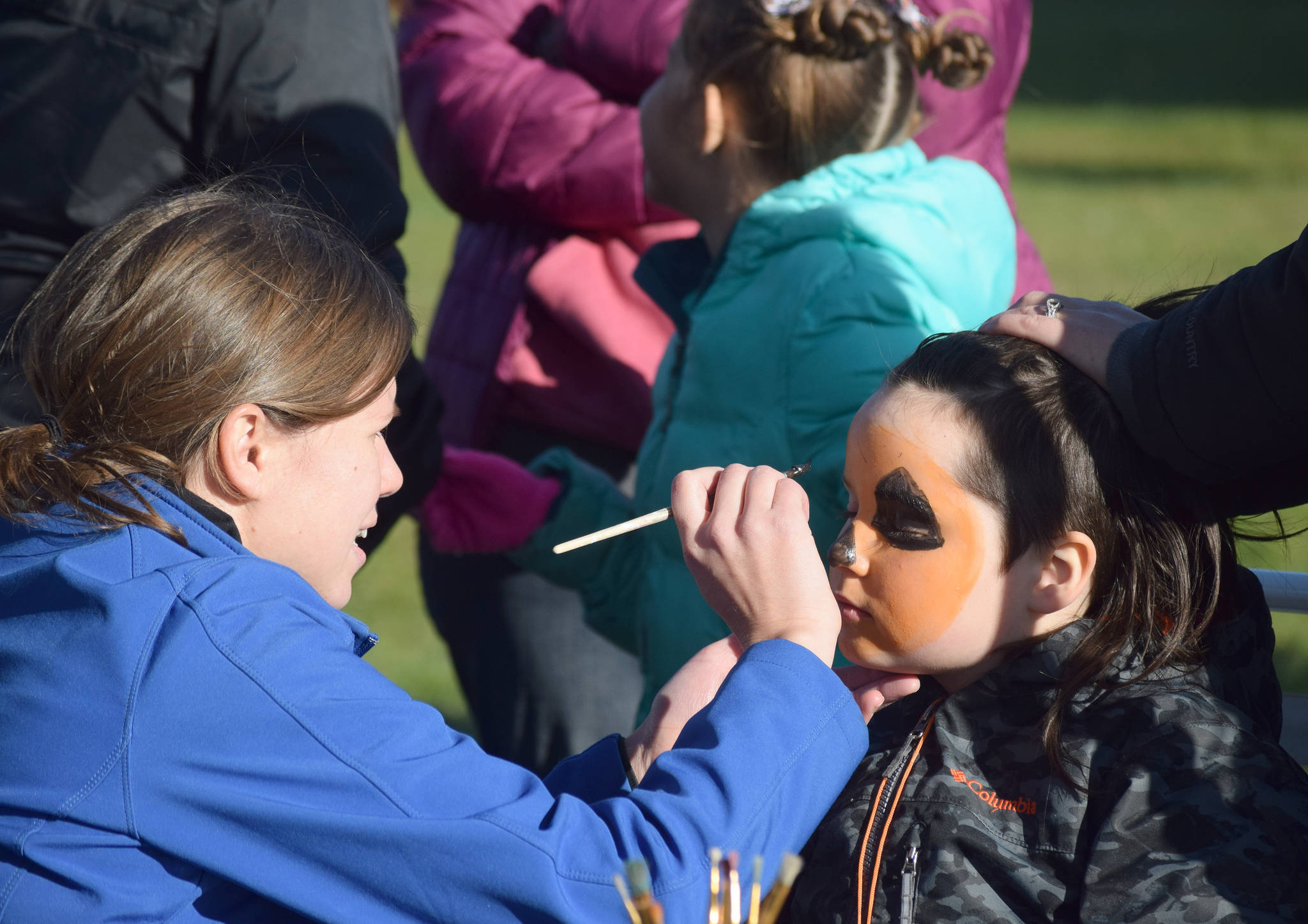 Children get their face painted Saturday, Oct. 12, 2019, at the fourth annual Fall Pumpkin Festival at Millenium Square in Kenai, Alaska. t. (Photo by Joey Klecka/Peninsula Clarion)