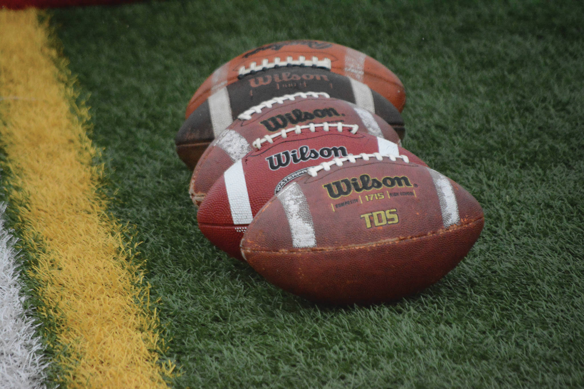 A row of footballs at the Homer-Seward game at Homer, Alaska, on Aug. 29, 2020. (Photo by Michael Armstrong/Homer News)