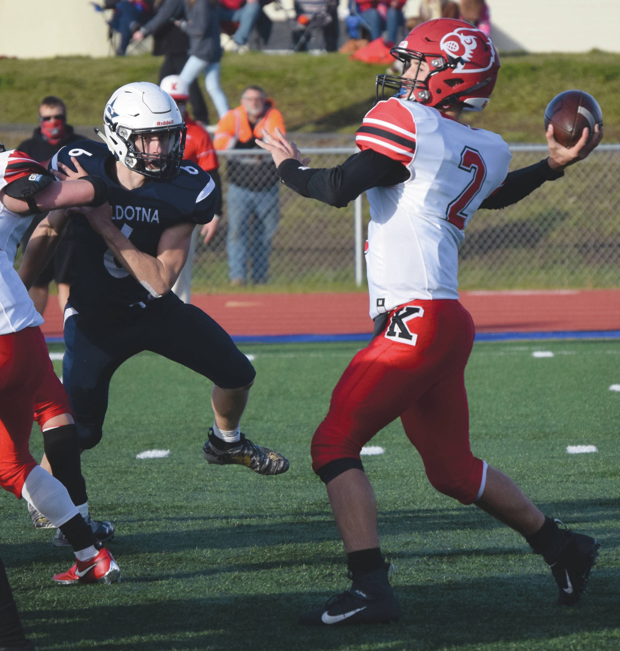 Kenai Central quarterback Bridger Beck passes under pressure from Soldotna’s Wayne Mellon on Friday, Oct. 9, 2020, at Justin Maile Field in Soldotna, Alaska. (Photo by Jeff Helminiak/Peninsula Clarion)