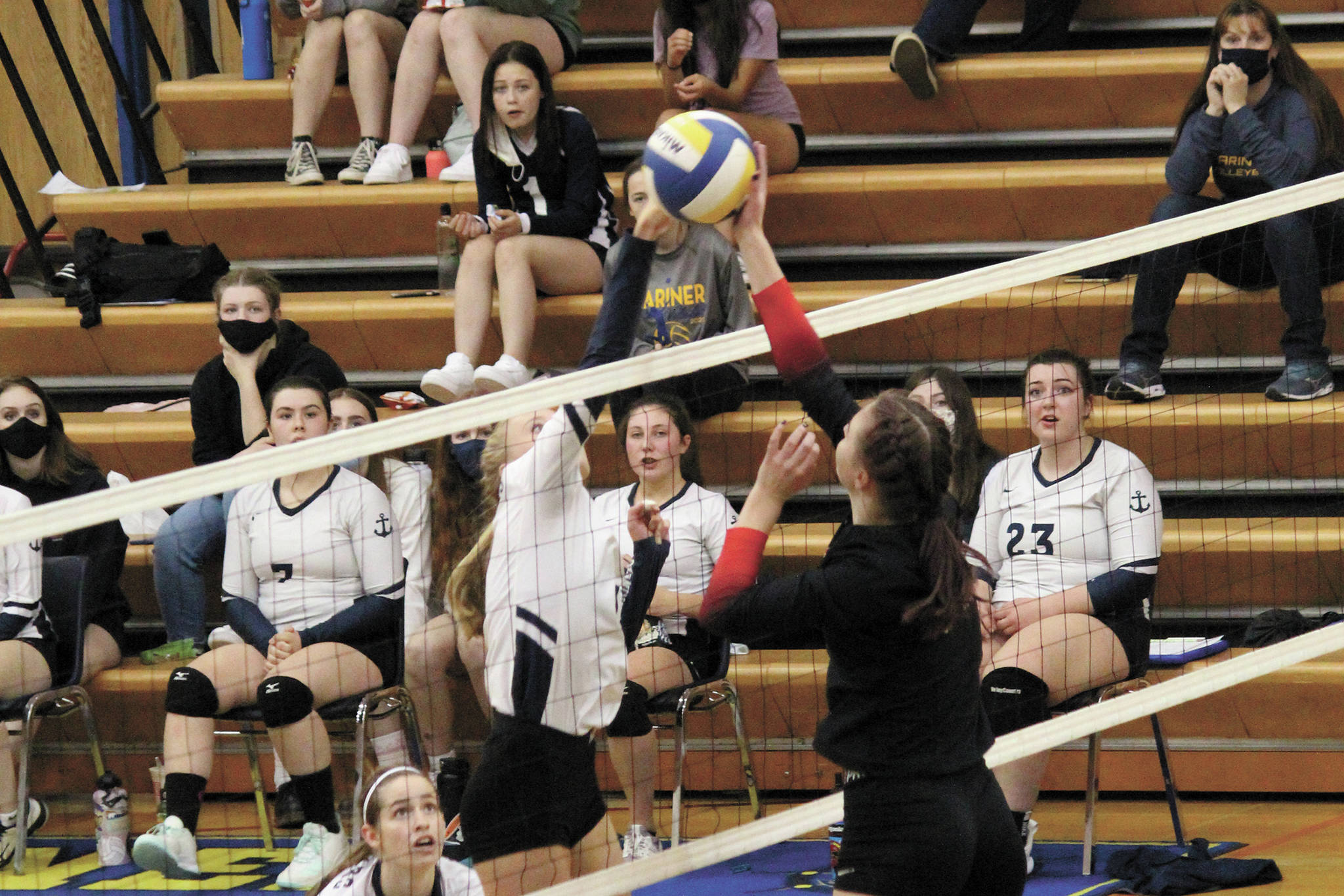 Homer’s Gracie Gummer and Kenai’s Erin Koziczkowski meet across the net during a Tuesday, Oct. 6, 2020 volleyball game in the Alice Witte Gymnasium in Homer, Alaska. (Photo by Megan Pacer/Homer News)