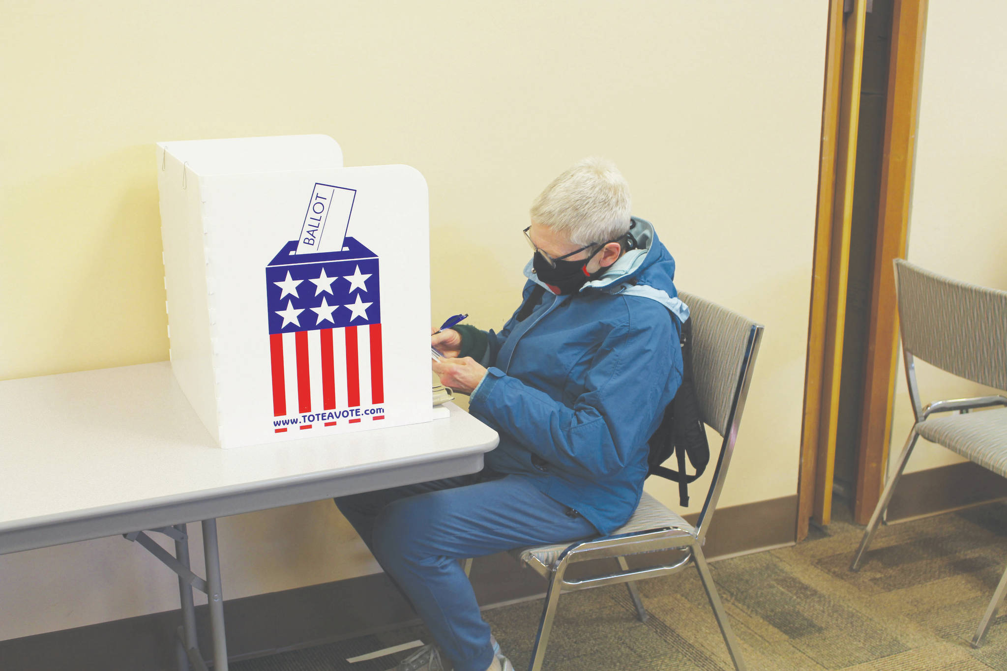 Linda Galloway, of Kenai, fills out her absentee ballot at Kenai City Hall on Wednesday. (Photo by Brian Mazurek/Peninsula Clarion)