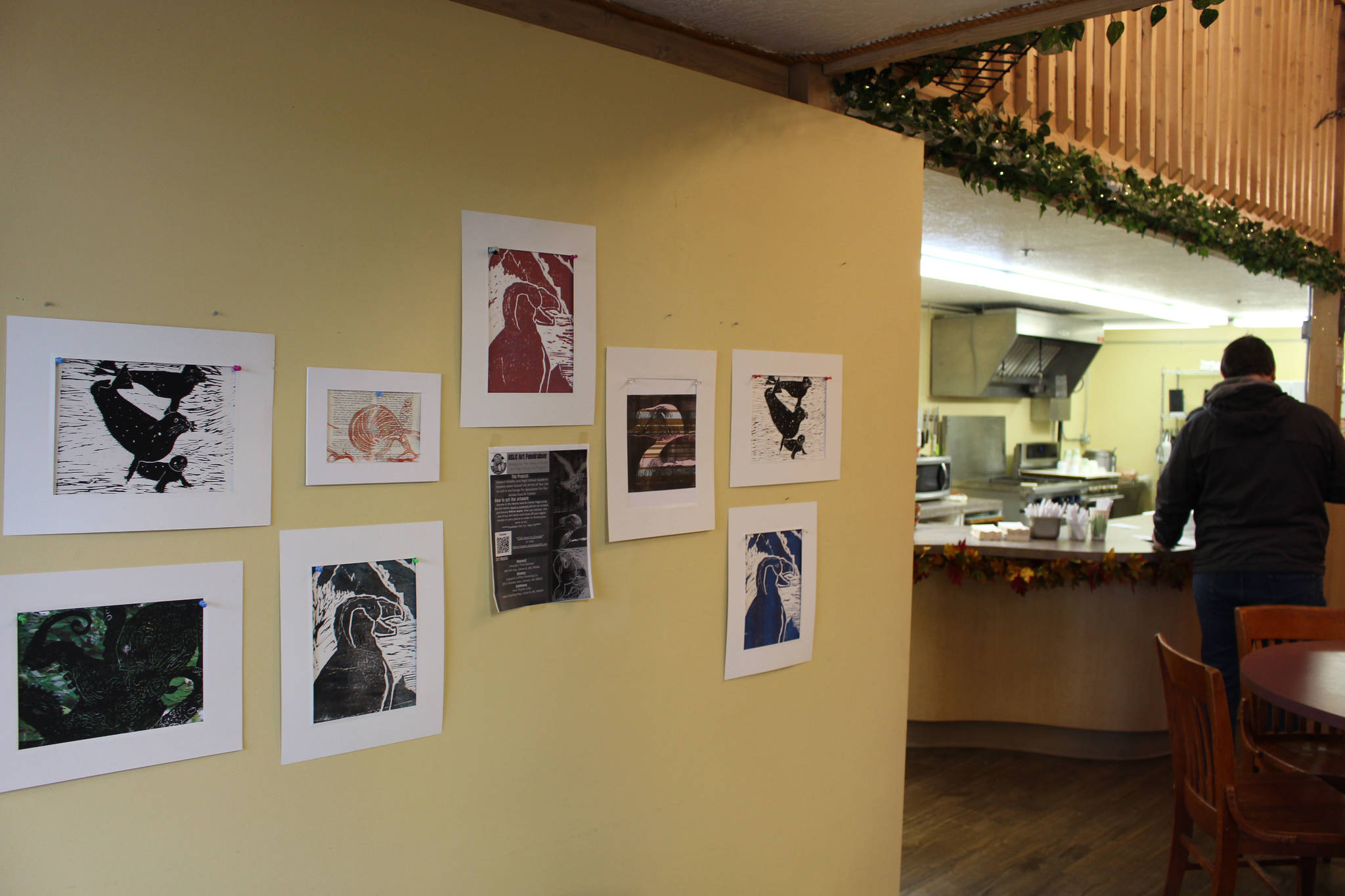 Linoleum prints made by Seward Middle and High School students are seen on display at Fine Thyme Cafe in Soldotna, Alaska on Oct. 23, 2020. Anyone who brings in a receipt showing they donated $10 or more to the Alaska SeaLife Center in Seward gets to take home a print of their choice. (Photo by Brian Mazurek/Peninsula Clarion)