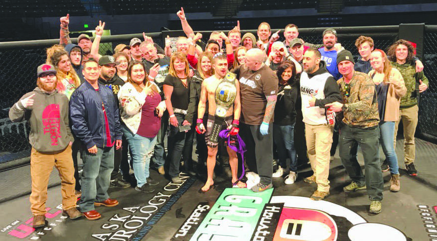 Supporters surround Victor Rodriguez after he won the Alaska Fighting Championship bantamweight title on Feb. 26, 2020, at the Alaska Airlines Center in Anchorage, Alaska. (Photo courtesy of Seth Stacey)