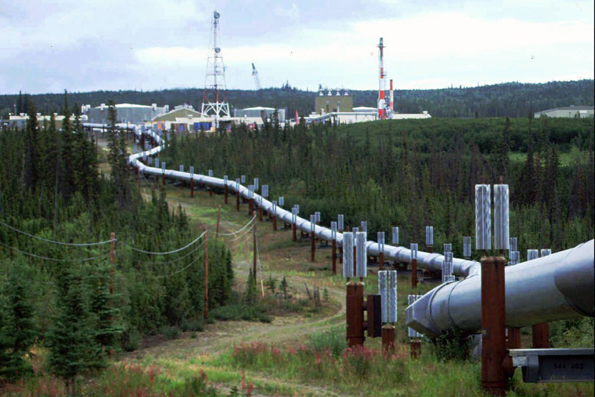 This undated file photo shows the Trans-Alaska pipeline and pump station north of Fairbanks, Alaska. (AP Photo/Al Grillo, File)FILE - This undated file photo shows the Trans-Alaska pipeline and pump station north of Fairbanks, Alaska. The future of Alaska’s unique program of paying residents an annual check is in question, with oil prices low and an economy struggling during the coronavirus pandemic. (AP Photo/Al Grillo, File)