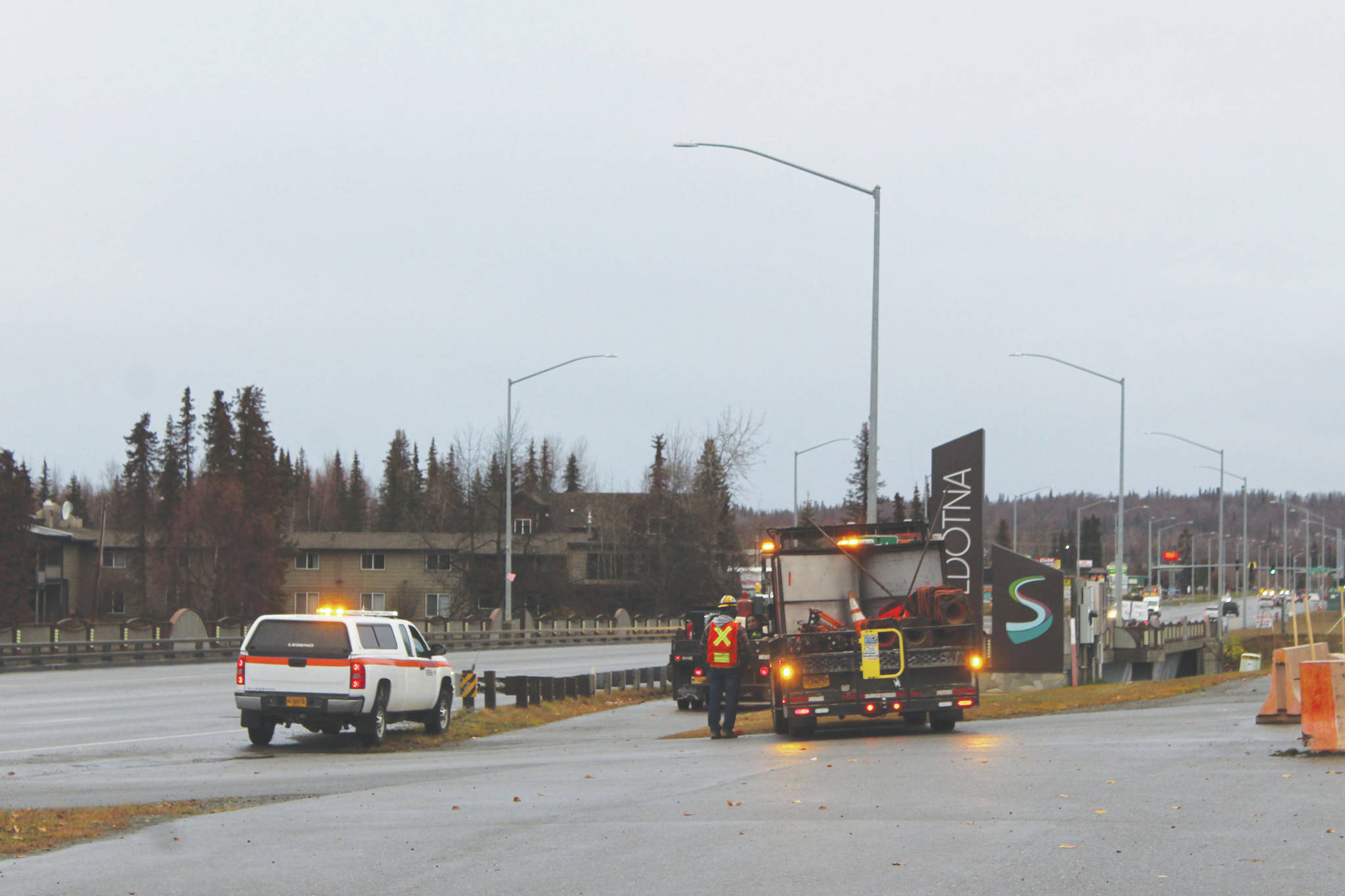 Crews work along the Sterling Highway over the Kenai River on Monday in Soldotna. (Photo by Ashlyn O’Hara/Peninsula Clarion)