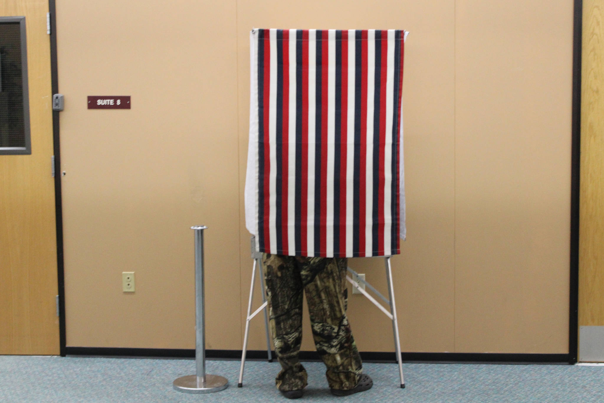 A man votes takes advantage of early voting at the Mendenhall Mall on Oct. 22, 2020. The FBI issued public guidance ahead of the general election warning voters about what is and isn’t federal election crime, and how to report such crimes if they’re spotted. (Ben Hohenstatt / Juneau Empire)