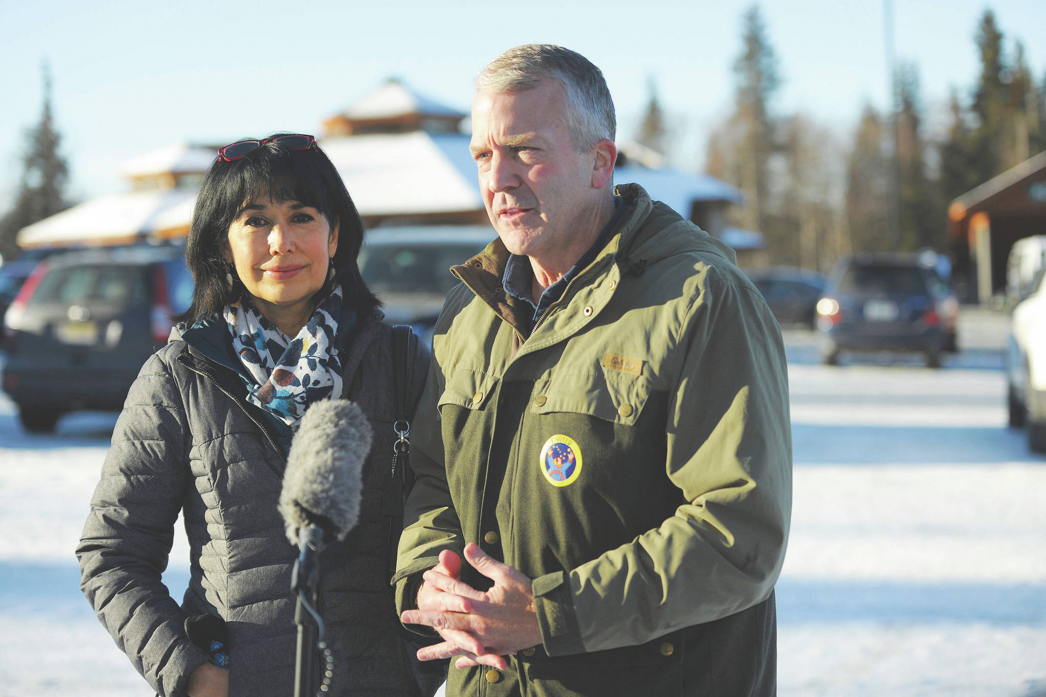 Incumbent Republican Sen. Dan Sullivan, left, with his wife Julie, speaks to the media after casting his ballot at the Alaska Zoo Tuesday, Nov. 3, 2020 in Anchorage, Alaska. (AP Photo/Michael Dinneen)