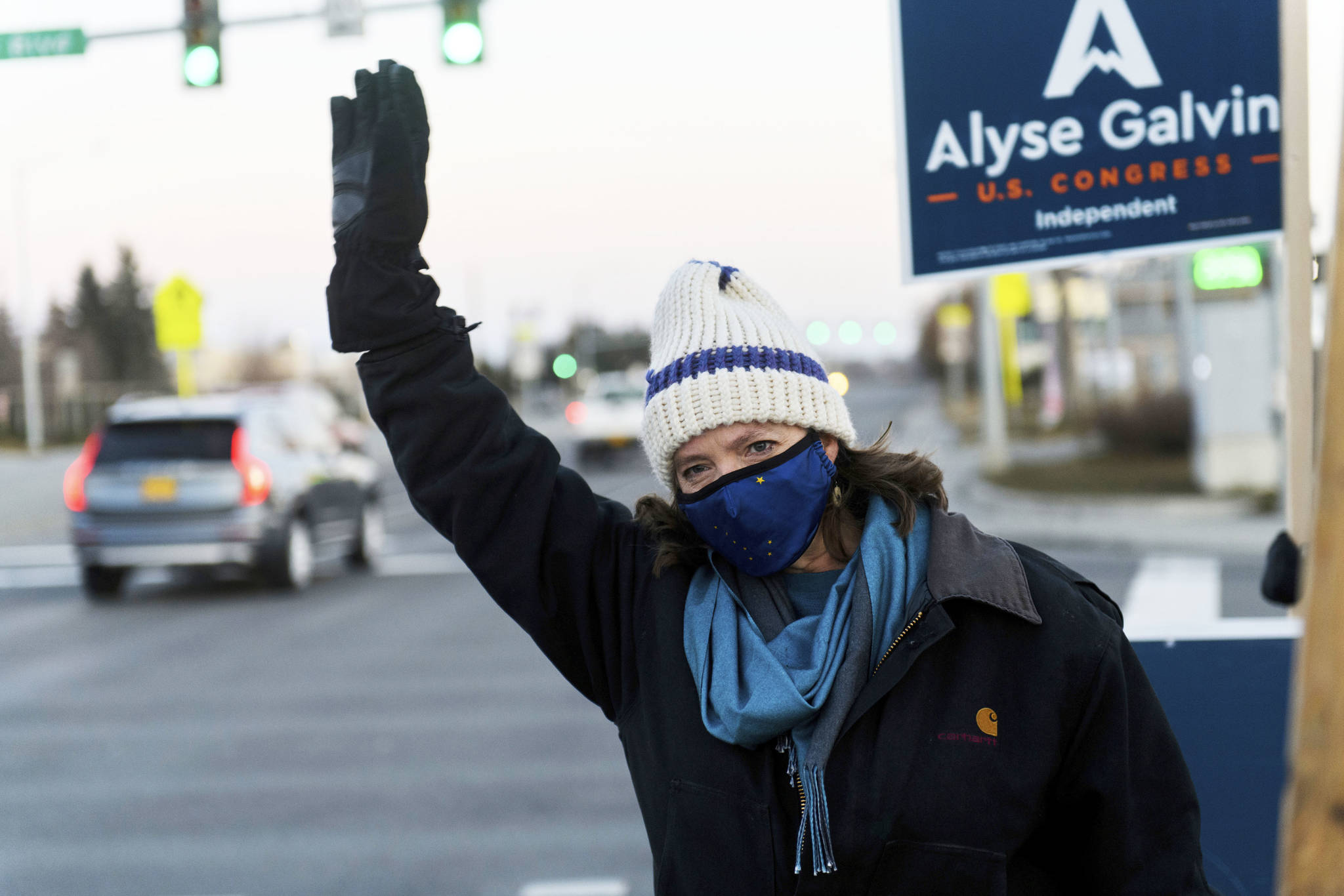 U.S. House Independent candidate Alyse Galvin waves to cars with supporters at Northern Lights Boulevard and Minnesota Drive on Election Day, Tuesday, Nov. 3, 2020, in Anchorage, Alaska. Galvin, an independent, is trying to unseat U.S. Rep. Don Young, Alaska’s sole member of the U.S. House and in office since 1973. (Marc Lester/Anchorage Daily News via AP)