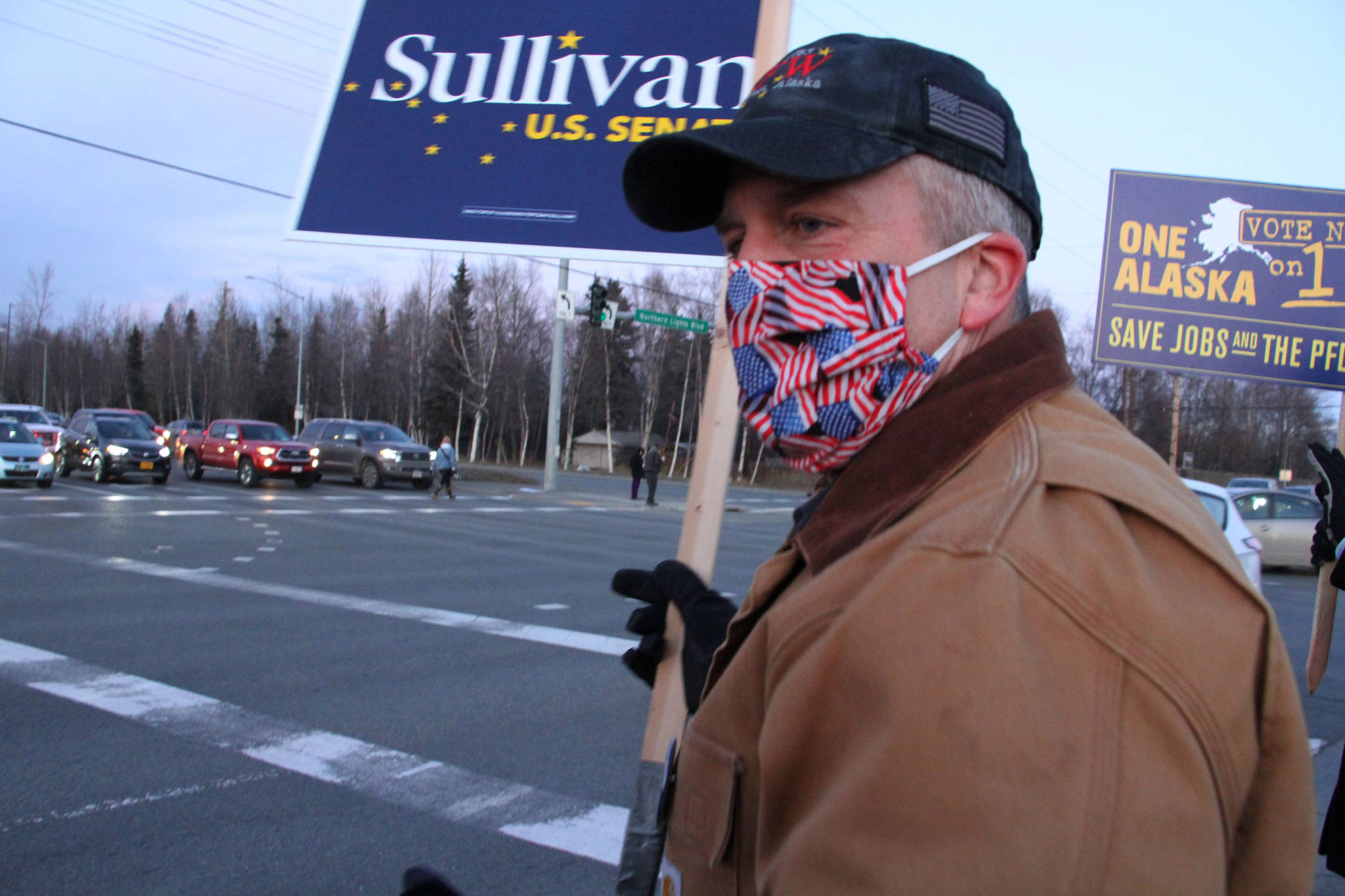 In this Nov. 2, 2020, file photo, Republican U.S. Sen. Dan Sullivan waves a sign at a busy intersection in Anchorage, Alaska. Sen. Sullivan on Wednesday, Nov. 11, 2020, won re-election in Alaska, defeating independent Al Gross. (AP Photo/Mark Thiessen, File)