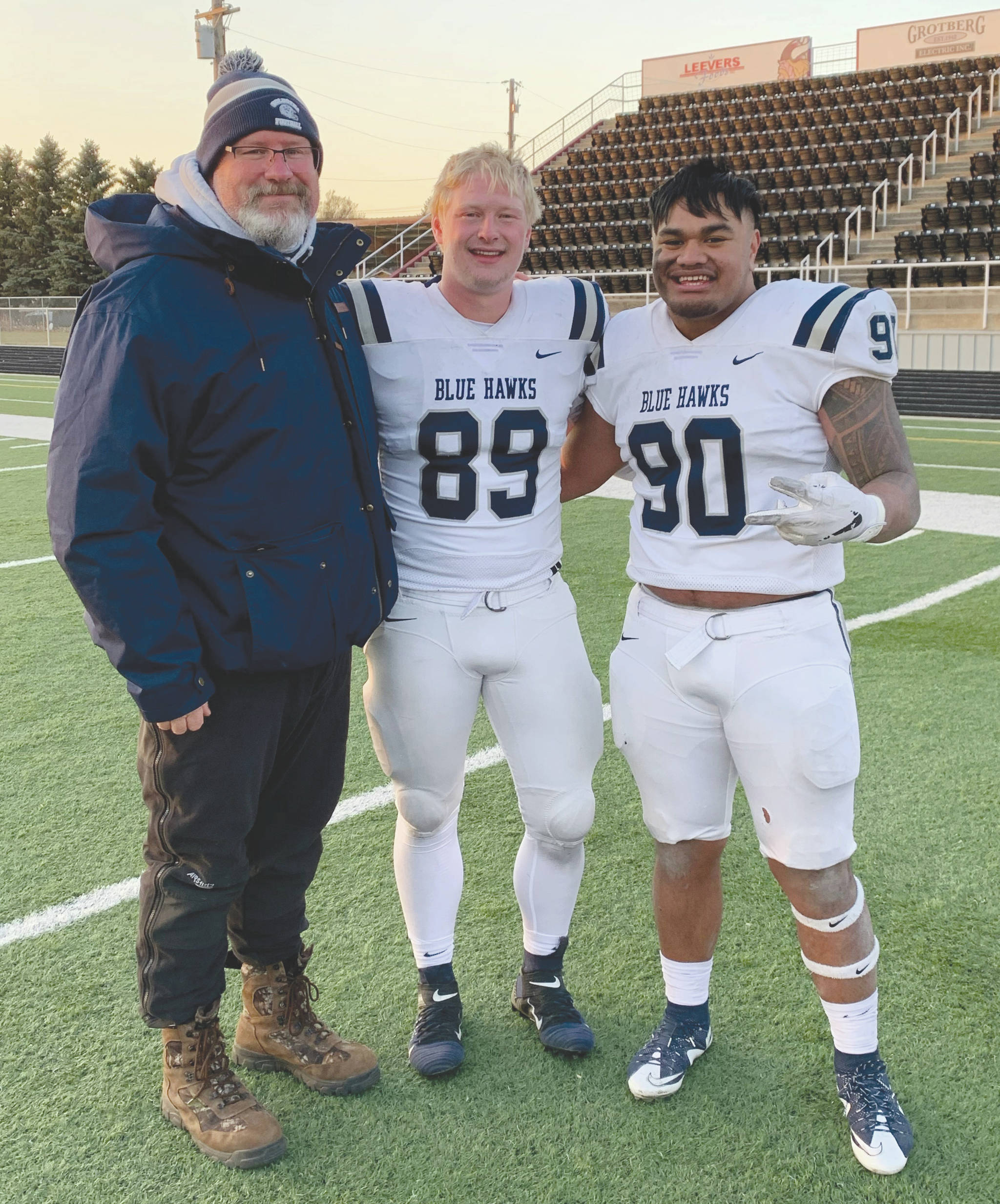 Soldotna High School head football coach Galen Brantley Jr. poses with former players Galen Brantley III and Aaron Faletoi. Brantley III and Faletoi helped Dickinson State in Dickinson, South Dakota, to an undefeated regular season. (Photo provided by Galen Brantley Jr.)