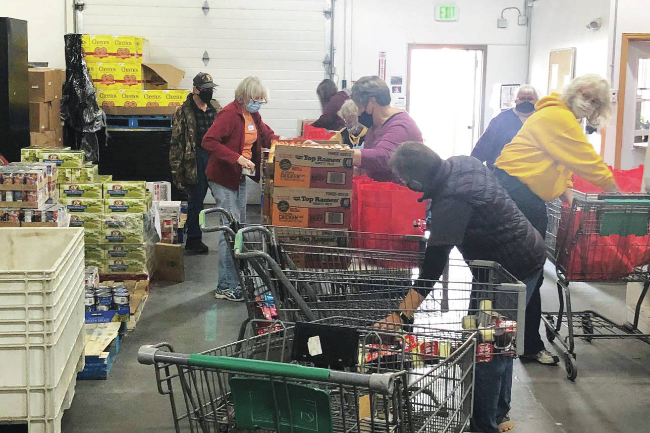 Photo courtesy Kenai Peninsula Food Bank
Kenai Peninsula Food Banks staff and volunteers assemble food bags for the cities of Kenai and Soldotna recently at the food bank, near Soldotna.