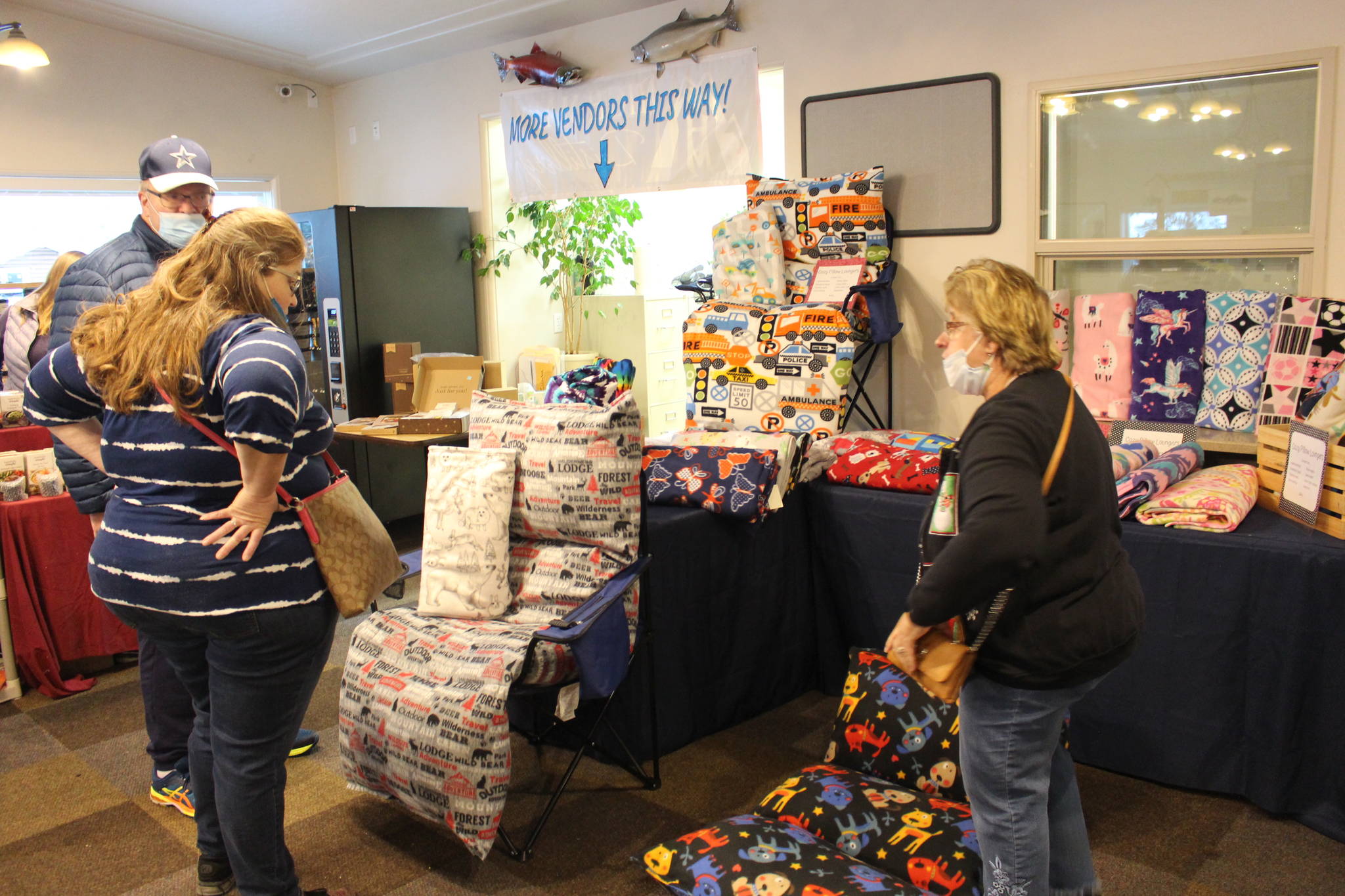 Brian Mazurek/Peninsula Clarion
Deray Jones, left, and Darla Jones, center, check out the “cozy pillow loungers” made by Becky Moore of Joyful Crafters, right, during the Sterling Fall Festival in Sterling, on Saturday.