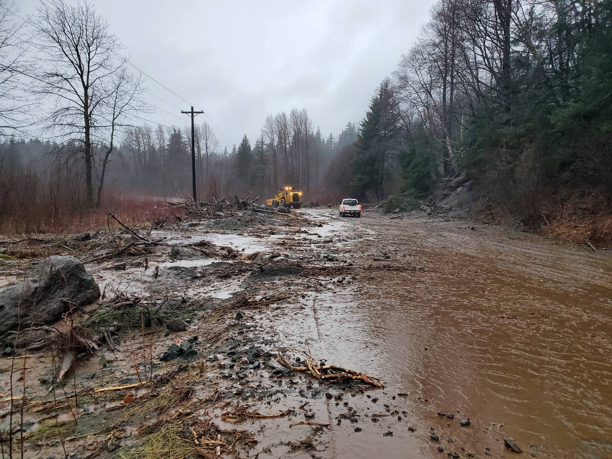 This photo provided by the Alaska Department of Transportation and Public Facilities shows damage from heavy rains and a mudslide 600 feet wide in Haines, Alaska, on Wednesday, Dec. 2, 2020. Authorities say six people are unaccounted for, and four homes were destroyed in the slide, with the search resuming Thursday morning for survivors. (Matt Boron / Alaska Department of Transportation and Public Facilities)