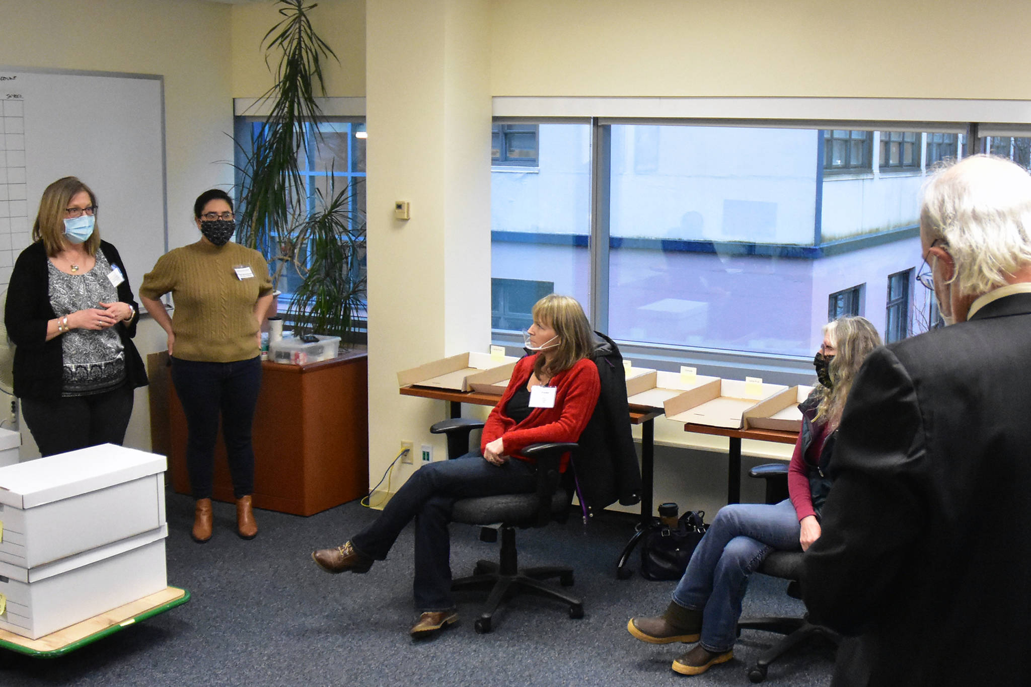 Division of Elections Director Gail Fenumiai, left, explains the recount process to DOE staff and members of the State Review Board during a recount of votes from Anchorage House District 27 where a Democratic challenger ousted a Republican incumbent by just 13 votes. Friday, Dec. 4, 2020. (Peter Segall / Juneau Empire)