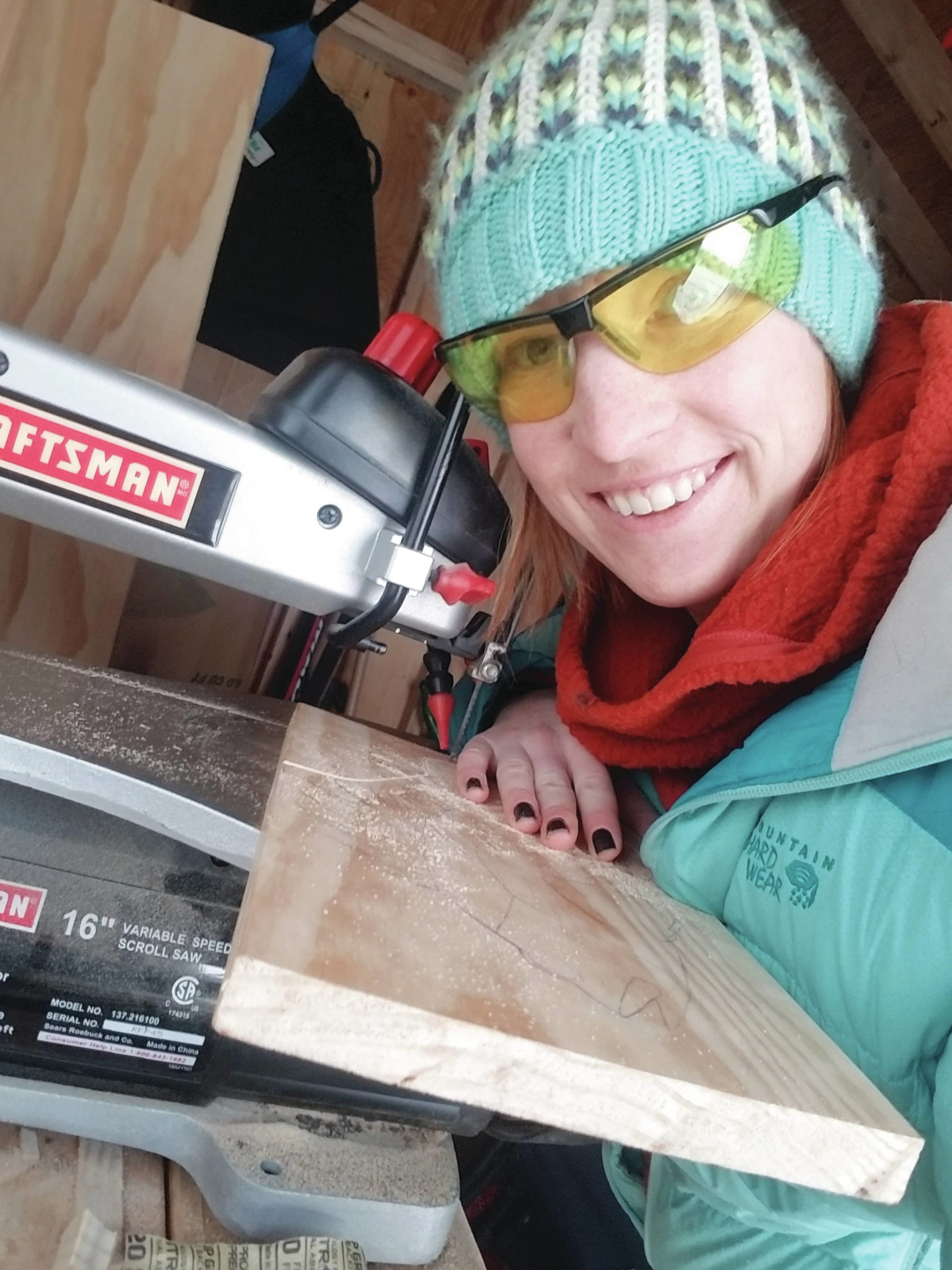 Kim Schuster poses with her scroll saw in a photo taken in November 2019 at her Homer, Alaska, workshop. (Photo courtesy Kim Schuster)
