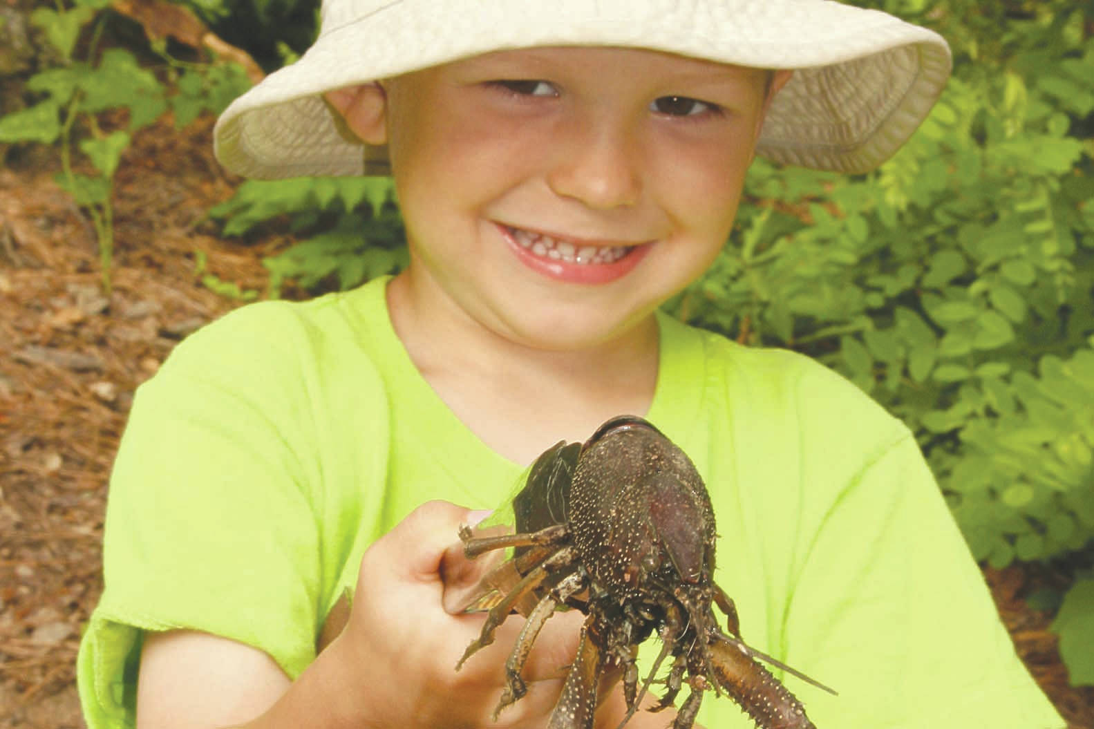 Wyatt, at age 4, helping dad harvest crawfish at White River NWR in Arkansas. (Photo by Matt Conner/USFWS)