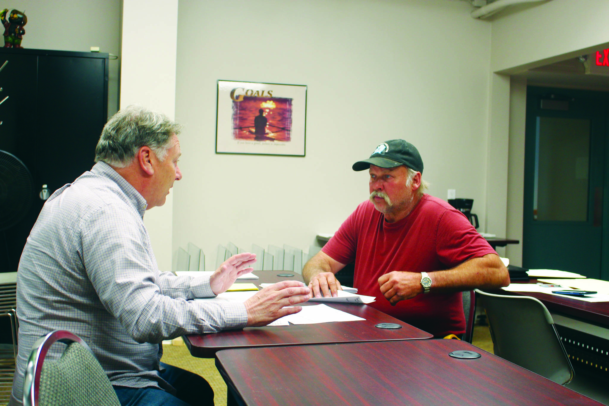 Tim Dillon, executive director of the Kenai Peninsula Economic Development District, helps Doug Weaver, owner of Northern Superior Construction, apply for an AK CARES grant through Credit Union 1 at the KPEDD office in Kenai, Alaska on July 1, 2020. (Photo by Brian Mazurek/Peninsula Clarion)