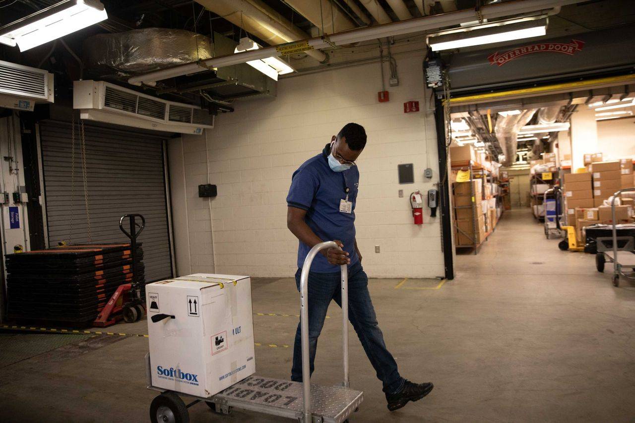 Supply Chain Technician Rebi Abdullahi pulls a box of Pfizer’s COVID-19 vaccines at Providence Alaska Medical Center on Monday, Dec. 14 in Anchorage, Alaska. (Photo courtesy of DHSS)