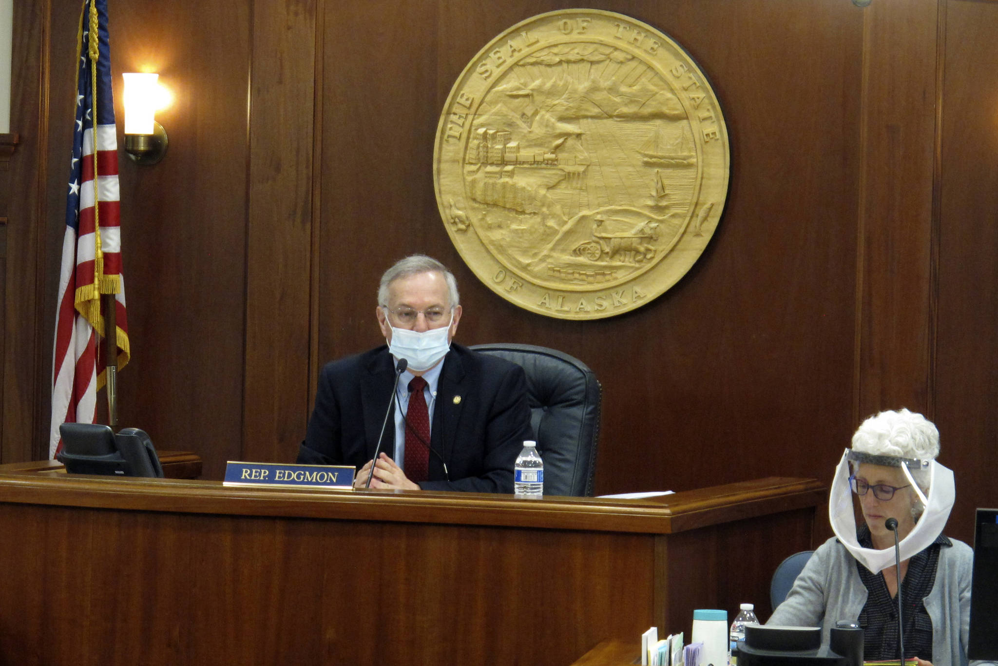 In this May 19, 2020, file photo, Alaska House Speaker Bryce Edgmon, left, presides over the House floor in Juneau, Alaska. Alaska lawmakers who each year relocate to a capital city accessible only by plane or boat are facing challenges in getting settled ahead of what is expected to be a difficult legislative session overshadowed by COVID-19. Speaker Edgmon, an independent from Dillingham, about 860 miles from Juneau, said pandemic concerns come at a time when lawmakers will need to make tough budget decisions. (AP Photo/Becky Bohrer, File)
