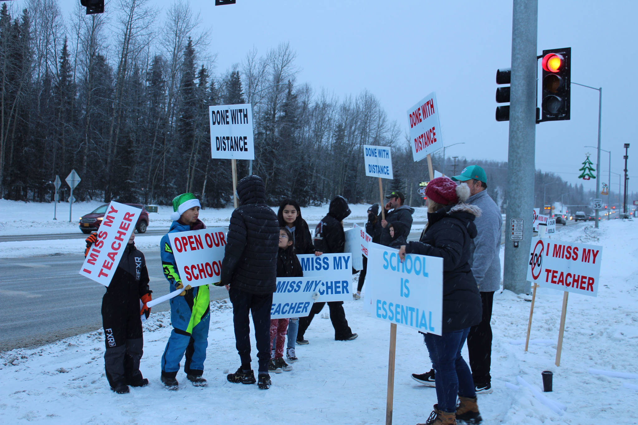 Protesters gather at the intersection of the Kenai Spur and Sterling highways on Tuesday, Dec. 15 in Soldotna, Alaska.