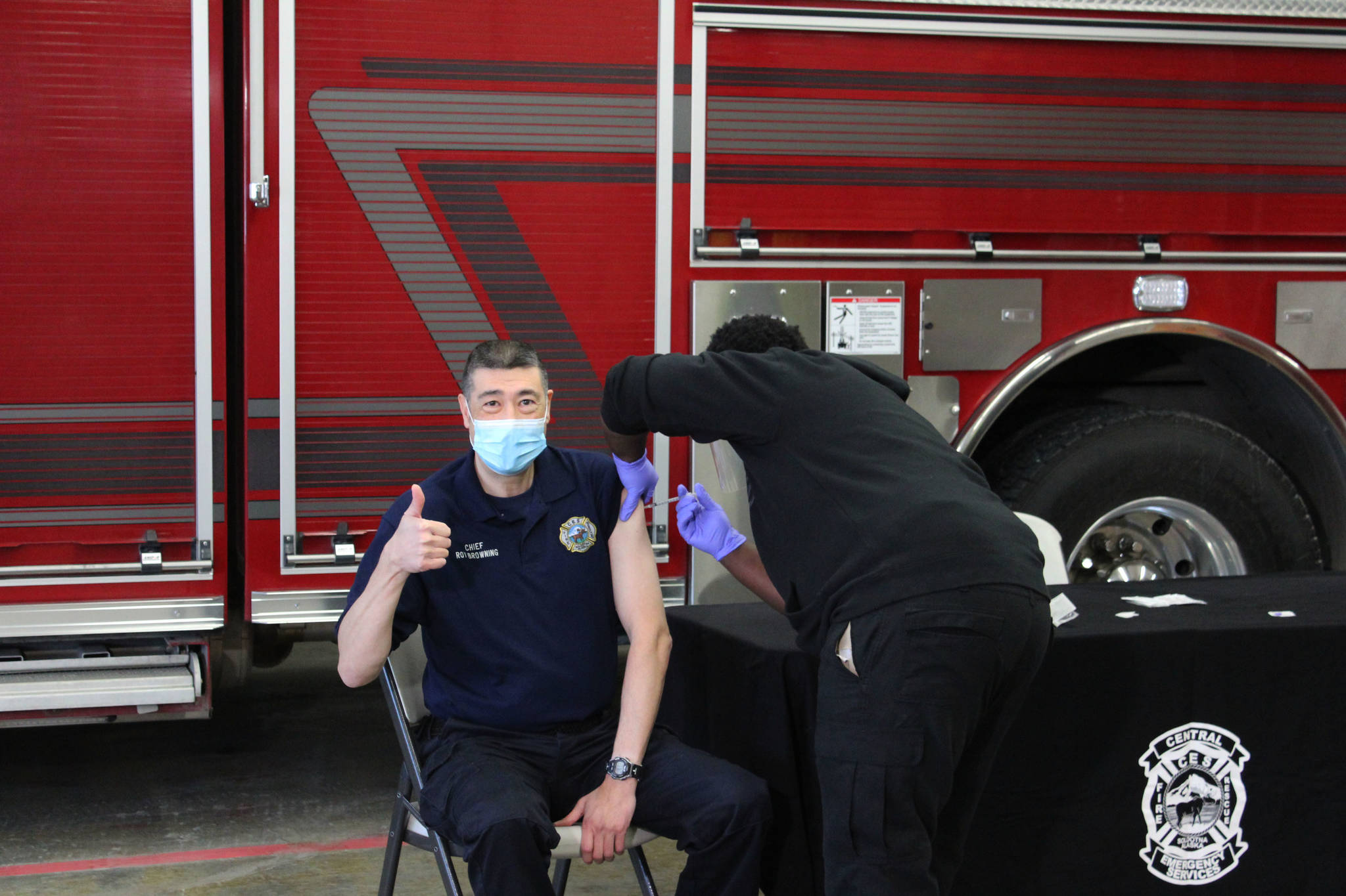 Harrison Deveer (right) administers a dose of Pfizer’s COVID-19 vaccine to Roy Browning (left) on Friday, Dec. 18 in Soldotna, Alaska. (Ashlyn O’Hara/Peninsula Clarion)