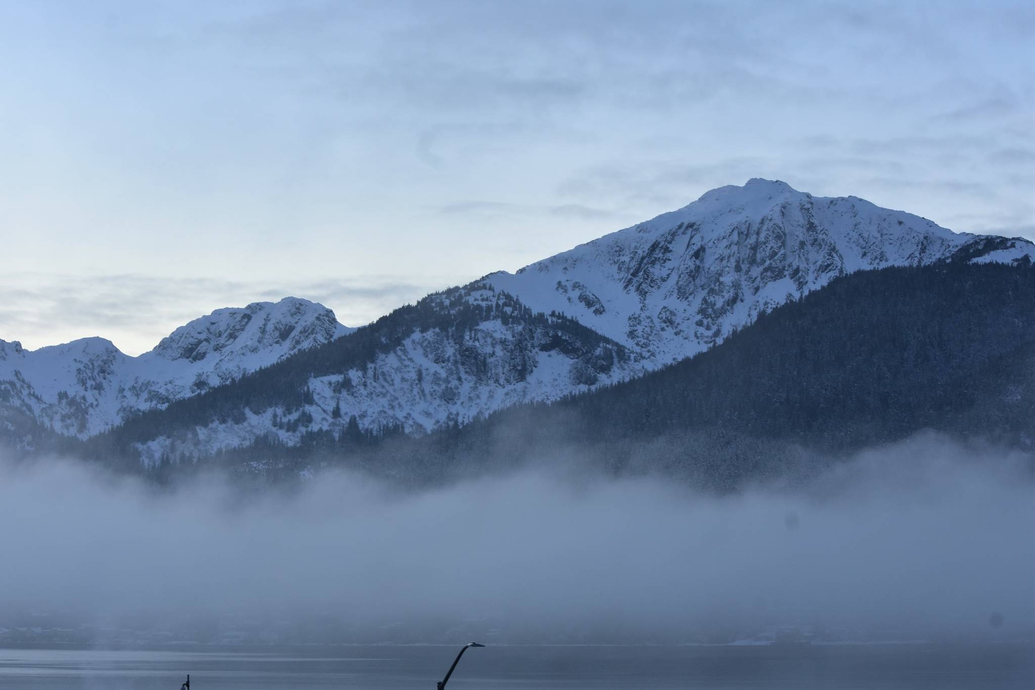 Peter Segall / Juneau Empire
Douglas Island, within the Tongass National Forest, breaks through the morning fog on Dec. 15. A federal investigation found the U.S. Forest Service violated federal law in 2018 when it appropriated a $2 million grant to Alaska for input on Roadless Rule changes.