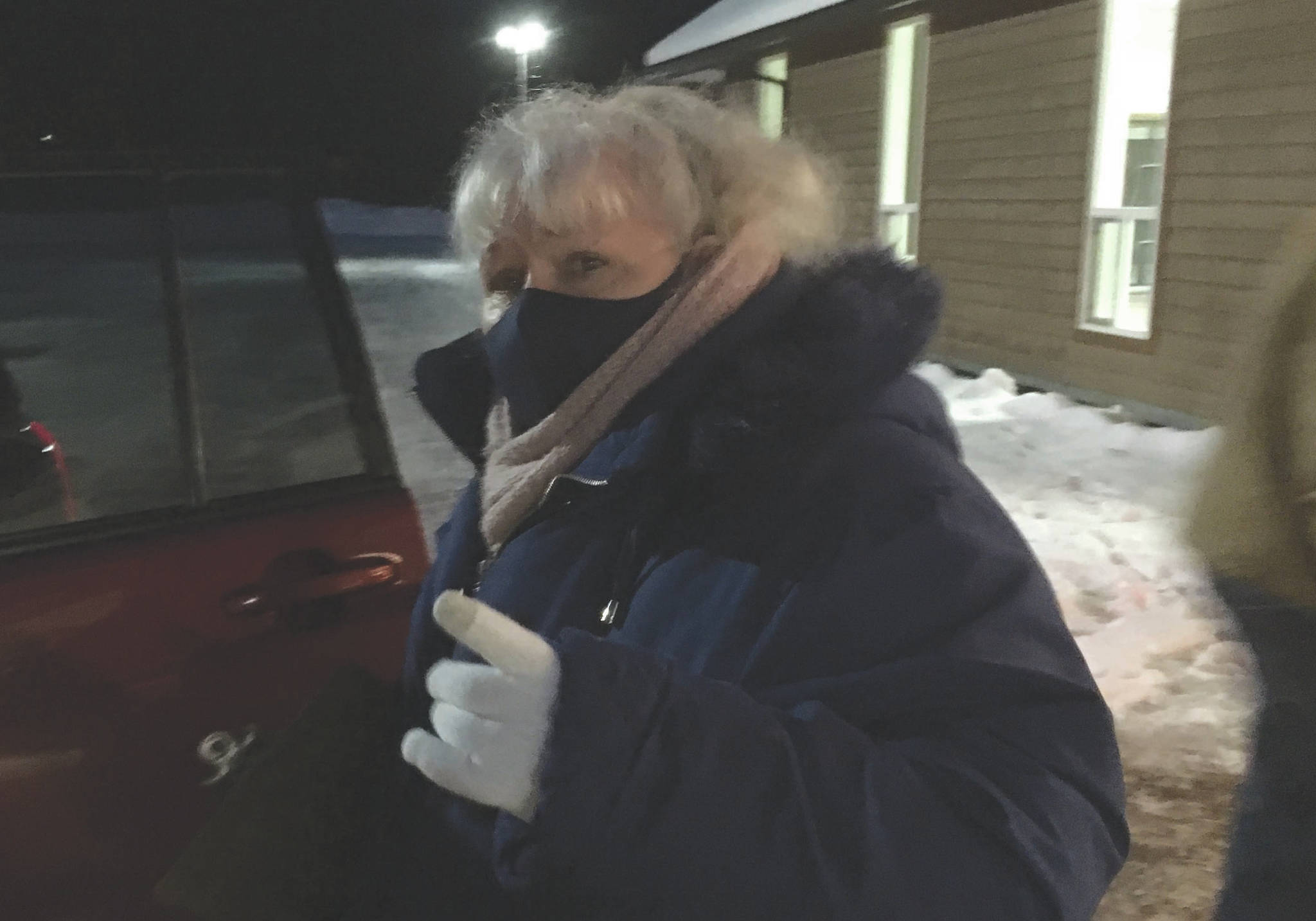 Kathy Carson helps distribute food bags from the Kenai Peninsula Food Bank on Tuesday, Dec. 22, 2020, at Christ Lutheran Church in Soldotna, Alaska. Carson is a volunteer with the church. (Photo by Jeff Helminiak/Peninsula Clarion)