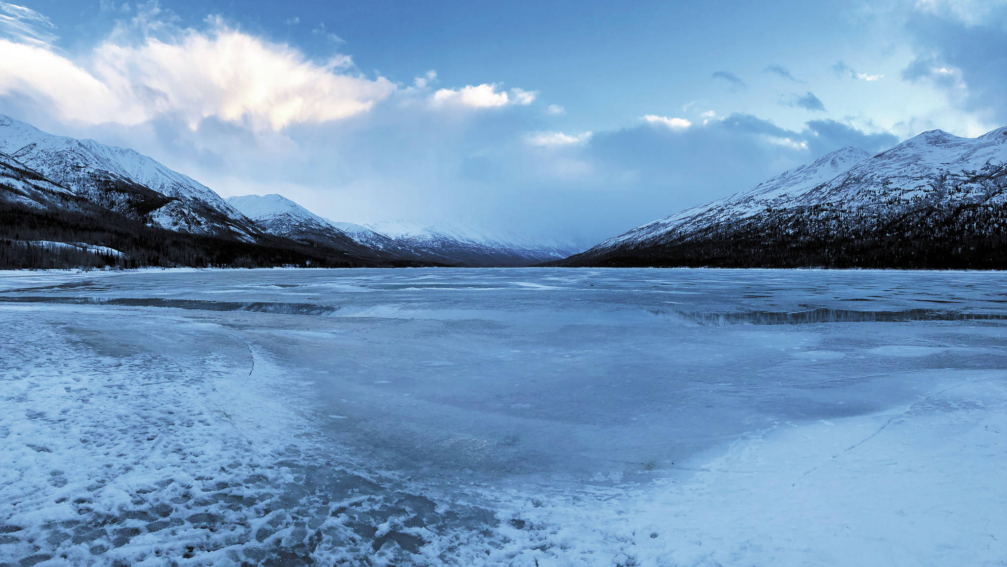 Blue skies can be seen beyond the clouds and fog settling on Eklutna Lake on Monday, Dec. 28, 2020 near Eagle River, Alaska. (Photo by Megan Pacer/Homer News)
