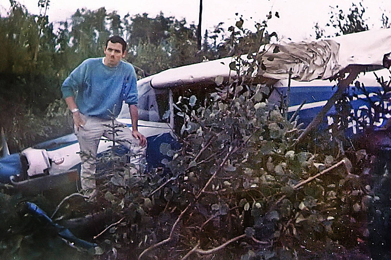 A few days after surviving an Aug. 2, 1967, crash in this single-engine Maule Rocket, Dane Parks poses near the front end of the wreckage. (Photo courtesy