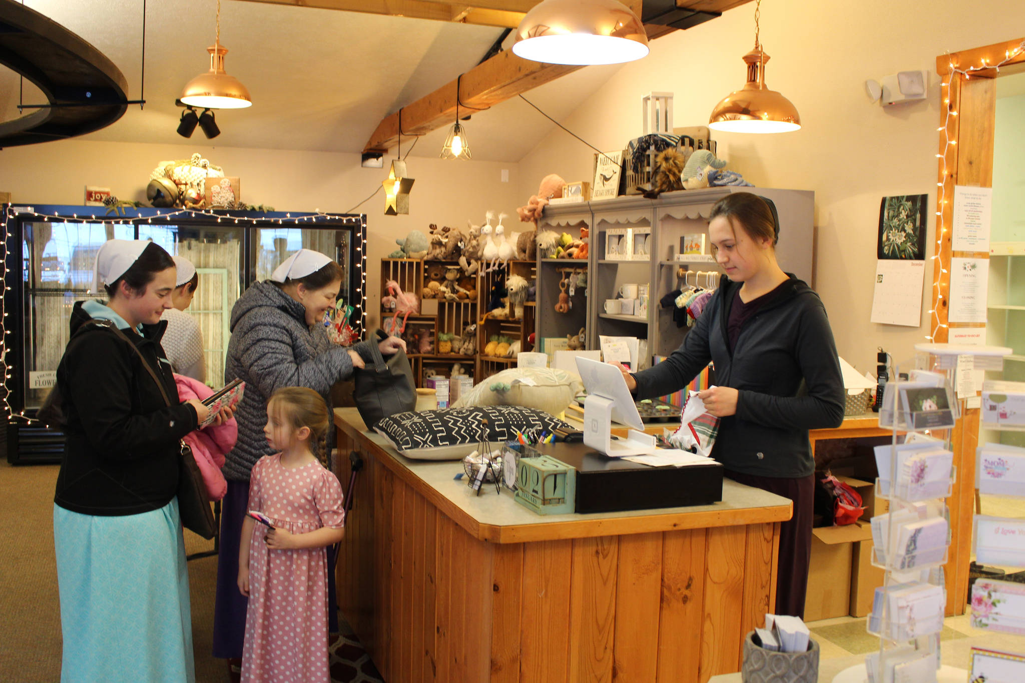 Brian Mazurek/Peninsula Clarion 
From left, Sheryl Christner, Julia Christner, Ruby Eicher and Audrey Christner shop at Kate’s Flowers and Gifts in Soldotna while Kate Mastre rings them up on Saturday.