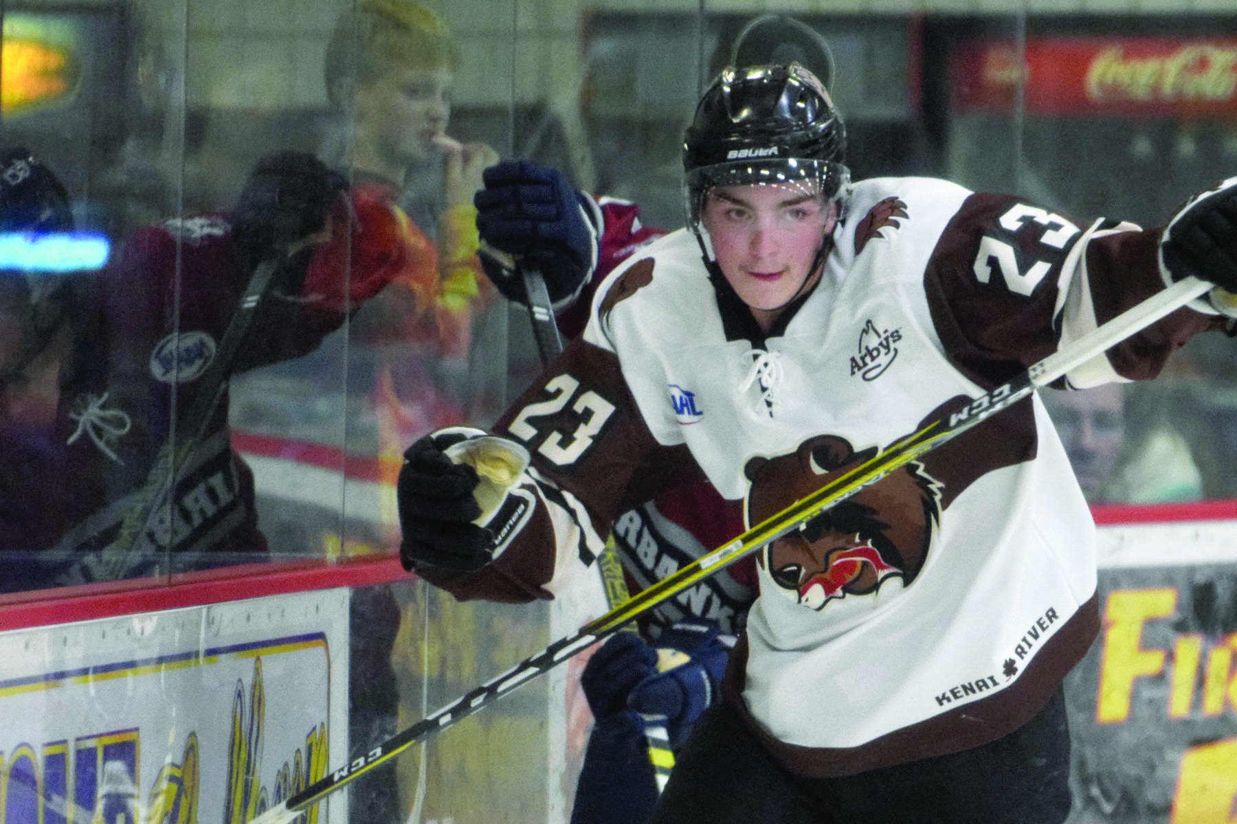 Kenai River Brown Bears forward Max Helgeson chases the puck along the boards against the Fairbanks Ice Dogs on Friday, Nov. 22, 2019, at the Soldotna Regional Sports Complex in Soldotna, Alaska. (Photo by Jeff Helminiak/Peninsula Clarion)