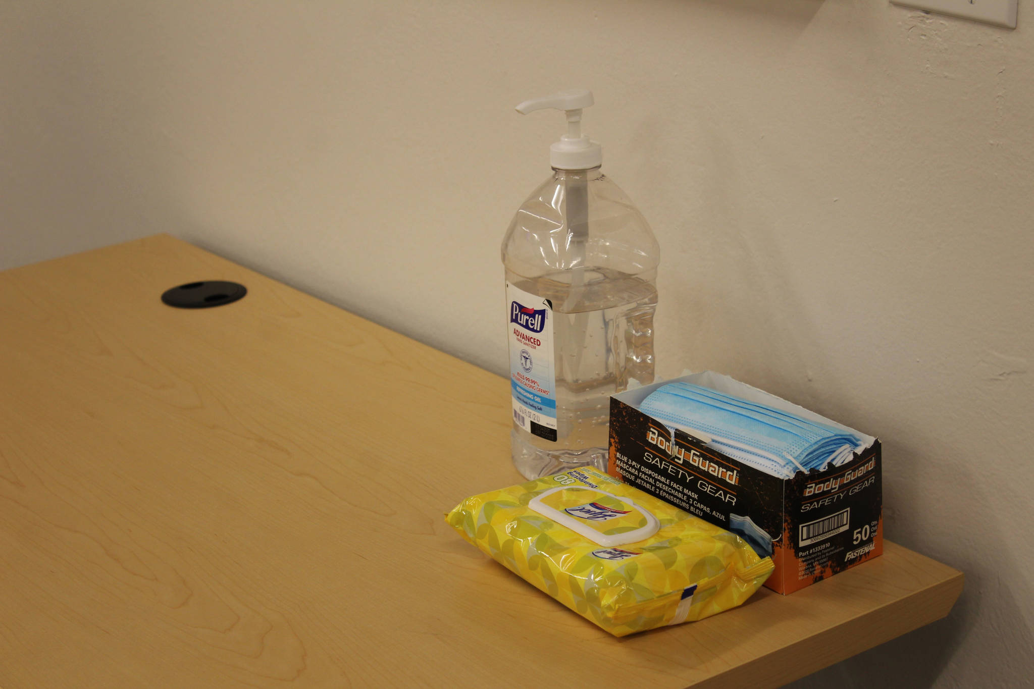 Hand sanitizer, disinfecting wipes and face masks are seen on a table inside of the Betty J. Glick Assembly Chambers on Monday, Jan. 4 in Soldotna, Alaska. (Ashlyn O’Hara/Peninsula Clarion)