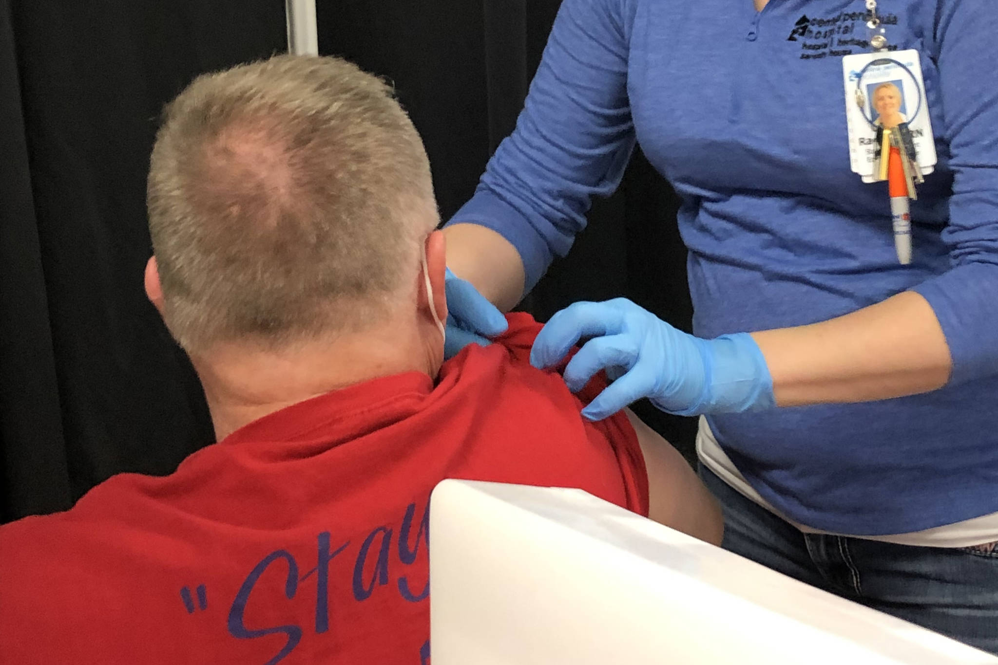 RN Rachel Verba (right) administers a dose of Pfizer’s COVID-19 vaccine to Dr. Chris Michelson (left) on Friday, Dec. 18, 2020 in Soldotna, Alaska. (Photo courtesy Bruce Richards/CPH)