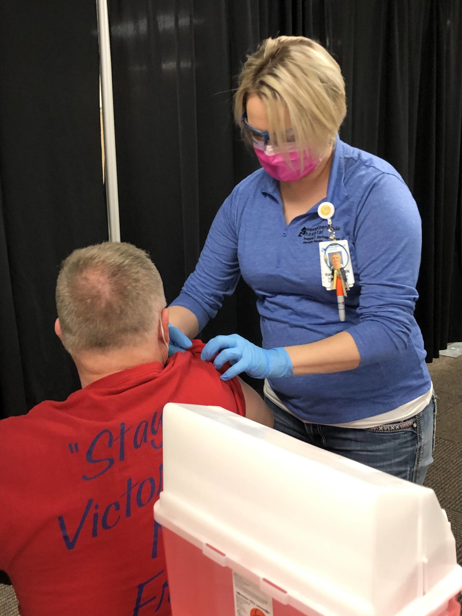 RN Rachel Verba (right) administers a dose of Pfizer’s COVID-19 vaccine to Dr. Chris Michelson (left) on Friday, Dec. 18, 2020 in Soldotna, Alaska. (Photo courtesy Bruce Richards/CPH)