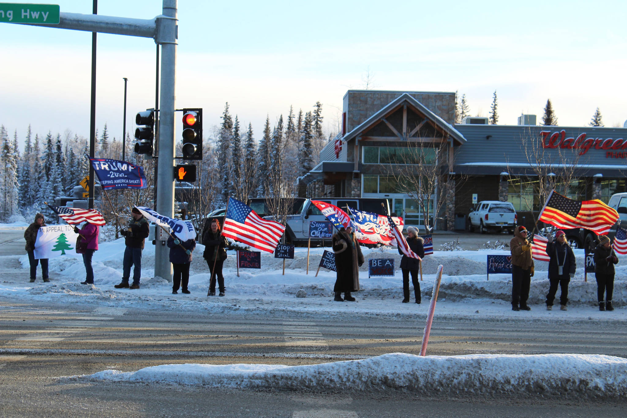 Demonstrators gather at the intersection of Kenai Spur and Sterling higways on Wednesday, Jan. 6 in Soldotna, Alaska. (Ashlyn O’Hara/Peninsula Clarion)