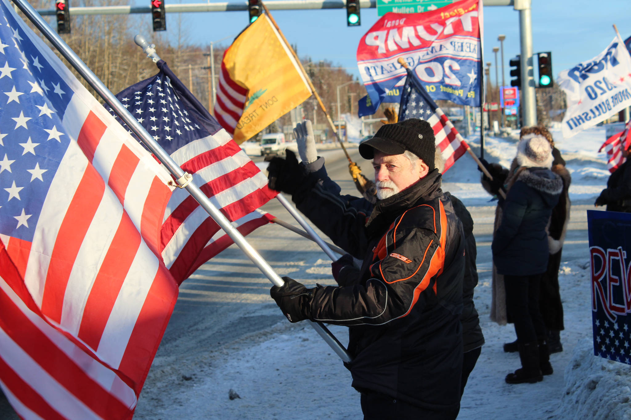 Ron Henry holds an American flag at the intersection of Kenai Spur and Sterling highways on Wednesday, Jan. 6 in Soldotna, Alaska. (Ashlyn O’Hara/Peninsula Clarion)