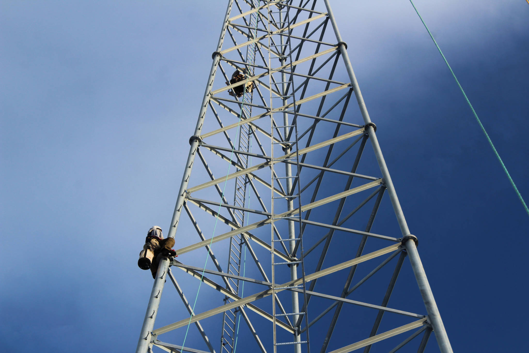 Billy Adamson (left) and Adam Kiffmeyer (right) scale a communications tower on Thursday, Jan. 7 in Nikiski, Alaska. (Ashlyn O’Hara/Peninsula Clarion)