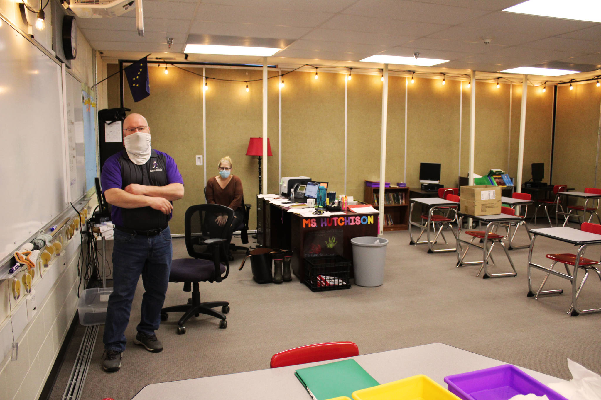 Vaughn Dosko (left) and Sarah Hutchison (right) discuss COVID-19 mitigation in Hutchison’s classroom at Kenai Middle School on Friday, Jan. 8 in Kenai, Alaska. (Ashlyn O’Hara/Peninsula Clarion)