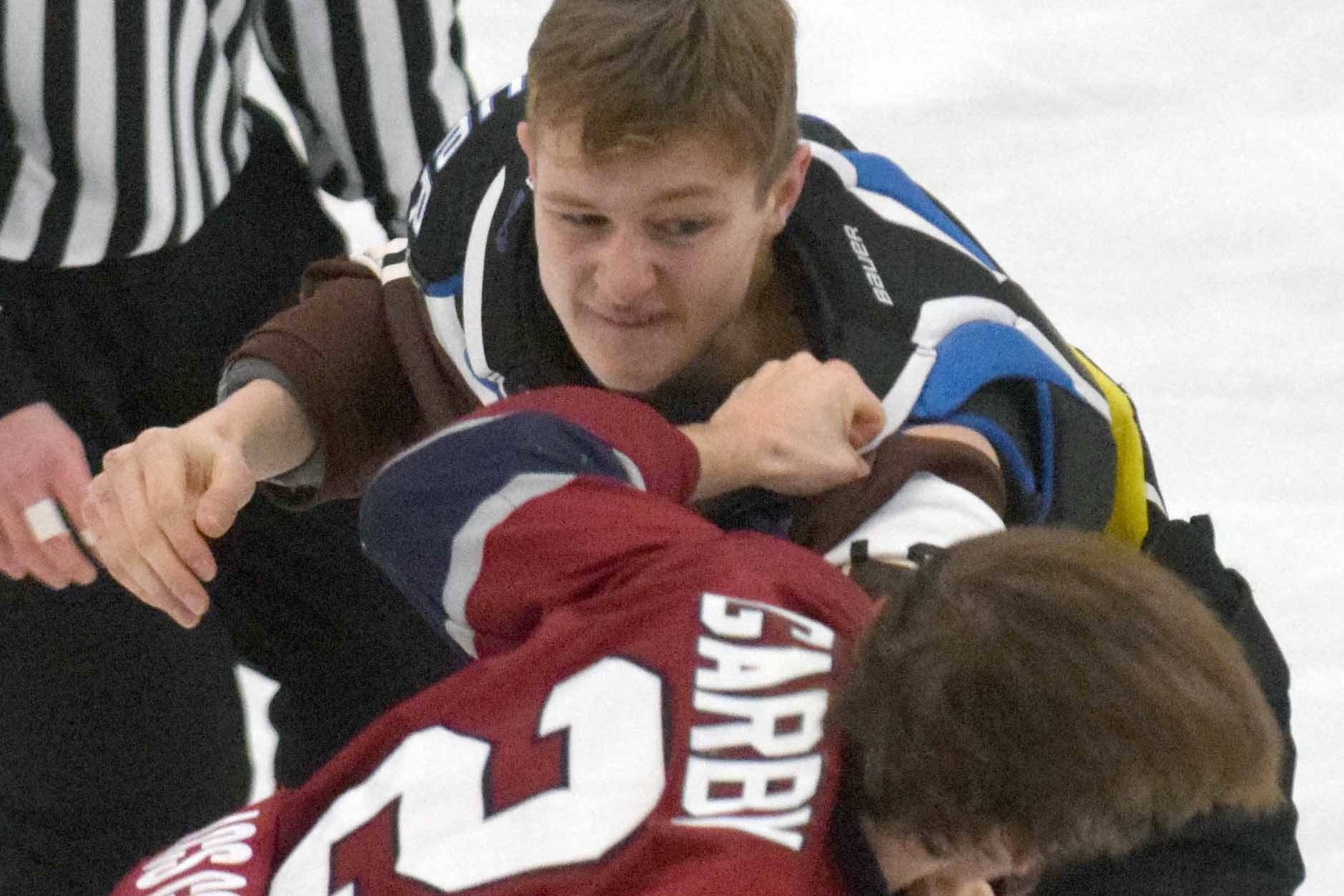 Kenai River Brown Bears forward Porter Schachle trades blows with Fairbanks Ice Dogs defenseman Andrew Garby on Friday, Nov. 22, 2019, at the Soldotna Regional Sports Complex in Soldotna, Alaska. (Photo by Jeff Helminiak/Peninsula Clarion)