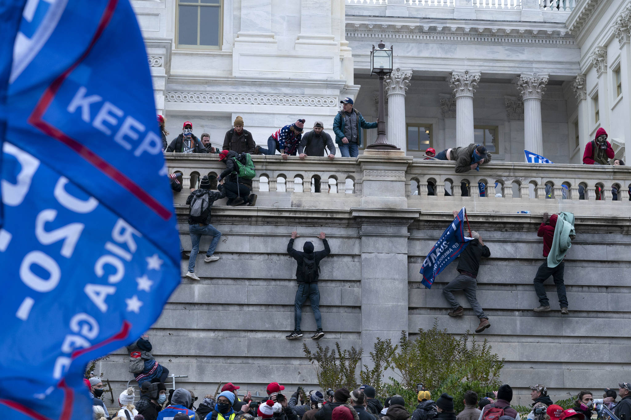 In this Wednesday, Jan. 6, 2021 file photo, supporters of President Donald Trump climb the West wall of the the U.S. Capitol in Washington. (AP Photo/Jose Luis Magana)