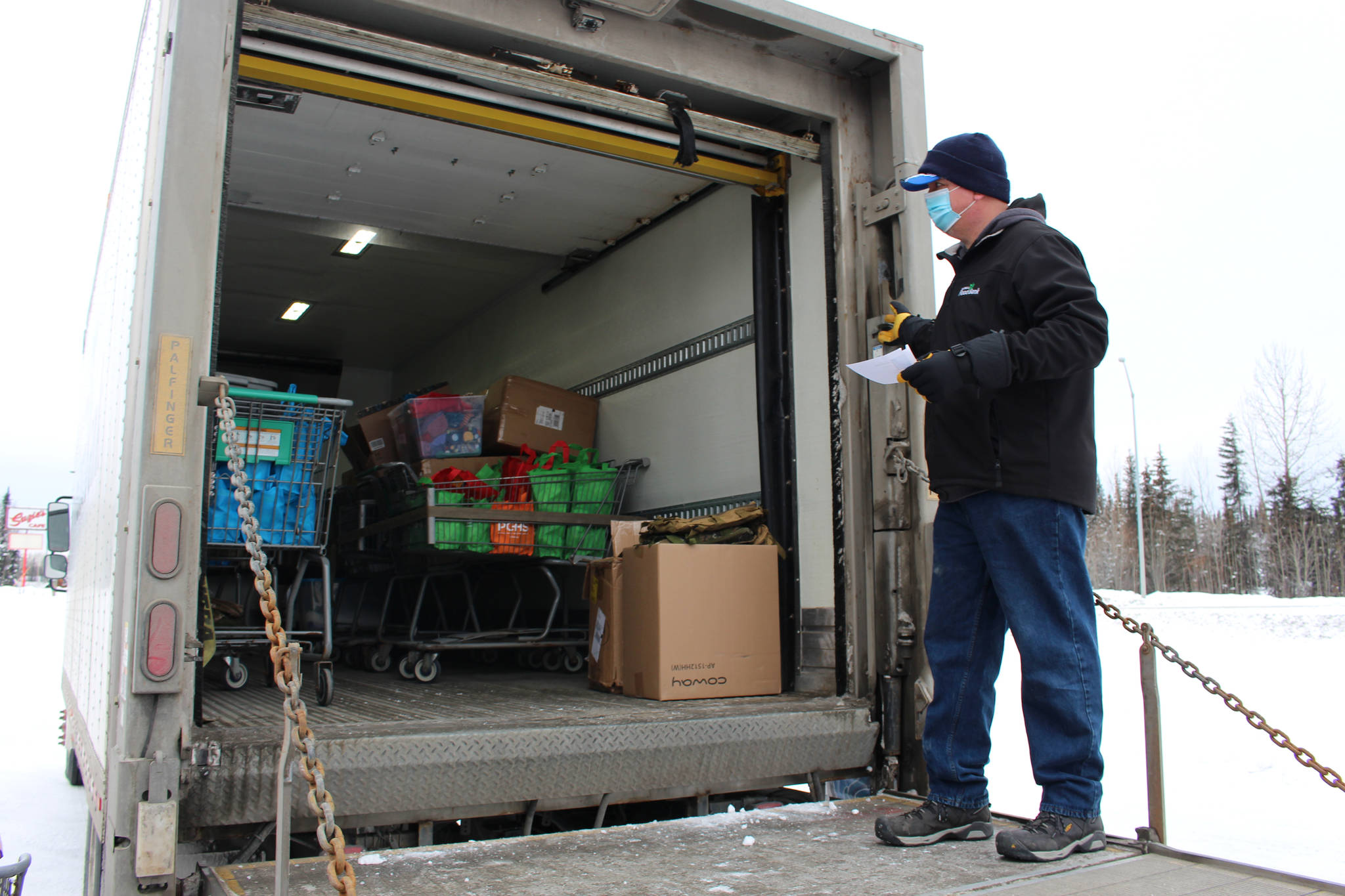 Roy Phillips unloads food and supplies for Project Homeless Connect at the Sterling Senior Citizens Center in Sterling, Alaska, on Feb. 2, 2021. (Photo by Brian Mazurek/Peninsula Clarion)