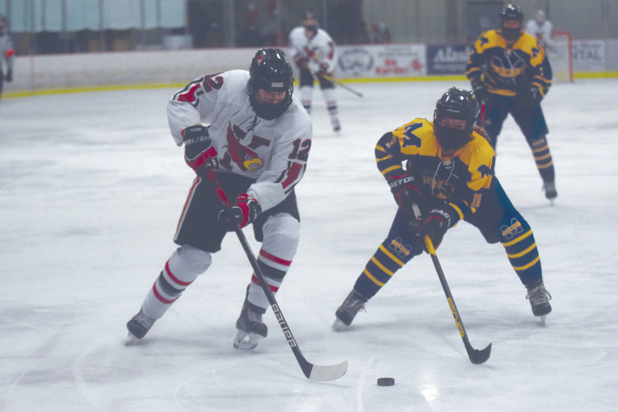 Kenai Centrals Landen Cialek attacks the net with Homers Fiona Hatton defending Tuesday, Feb. 2, 2021, at the Kenai Multi-Purpose Facility in Kenai, Alaska. (Photo by Jeff Helminiak/Peninsula Clarion)