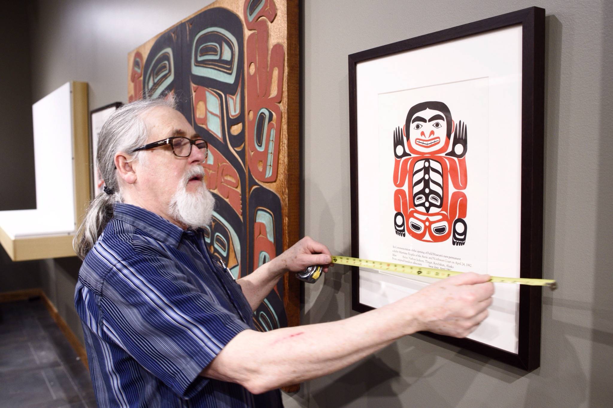 Michael Penn / Juneau Empire File
Paul Gardinier, an exhibit specialist, works to install a Nathan Jackson retrospective in the gallery at the Walter Soboleff Center on March 25, 2019.