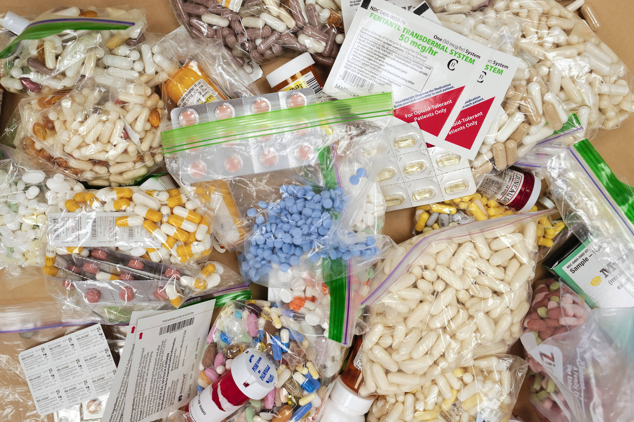 Prescriptions drugs, vitamins, hormones, and other drugs left in the drug drop box in the lobby of the Juneau Police Department in September 2019.The drop box gives residents a safe place to disposed of their unused prescription narcotics. The state announced on Thursday it will receive more than $1 million as part of a settlement with a consulting firm accused of “turbocharging” the opioid epidemic. (Michael Penn / Juneau Empire File)