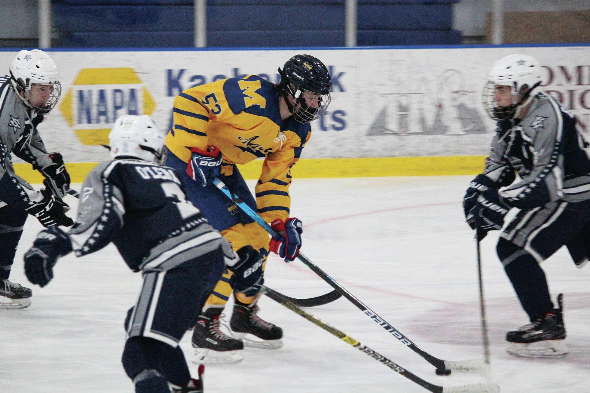 Homer’s Casey Otis takes the puck through a group of Soldotna Stars during a Saturday, Feb. 6, 2021 hockey game at the Kevin Bell Arena in Homer, Alaska. (Photo by Megan Pacer/Homer News)