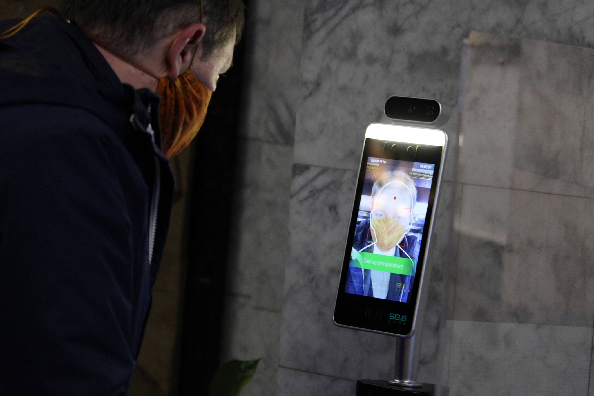 Ben Hohenstatt / Juneau Empire
State Sen. Jesse Kiehl, D-Juneau, has his temperature taken inside the Alaska State Capitol on Jan. 19. The high tech check-ins have become routine over the past few weeks.