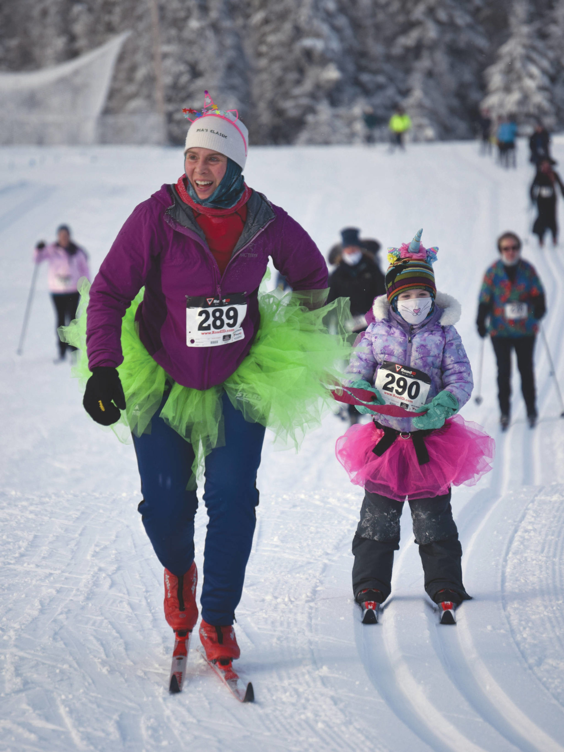 Carly Reimer tows daughter, Lois, at the 17th Ski for Women on Sunday, Feb. 7, 2021, at Tsalteshi Trails just outside of Soldotna, Alaska. (Photo by Jeff Helminiak/Peninsula Clarion)